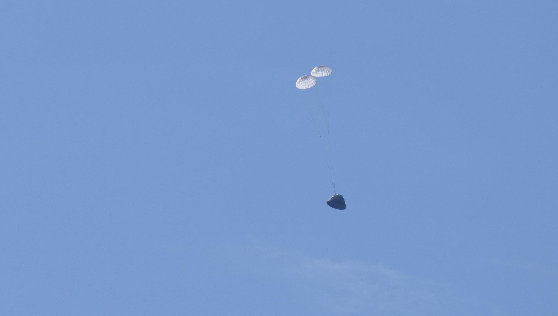 NASA’s Orion spacecraft with Artemis II crewmembers NASA astronauts Reid Wiseman, commander; Victor Glover, pilot; Christina Koch, mission specialist; and CSA (Canadian Space Agency) astronaut Jeremy Hansen, mission specialist aboard is seen under drogue parachutes as it lands in the Pacific Ocean off the coast of California, Friday, April 10, 2026. NASA’s Artemis II mission took Wiseman, Glover, Koch, and Hansen on a nearly 10-day journey around the Moon and back to Earth. Following a splashdown at 5:07 p.m. PDT (8:07 p.m. EDT), NASA, U.S. Navy, and U.S. Air Force teams are working to bring the crewmembers and Orion spacecraft aboard USS John P. Murtha.  Photo Credit: (NASA/Joel Kowsky)