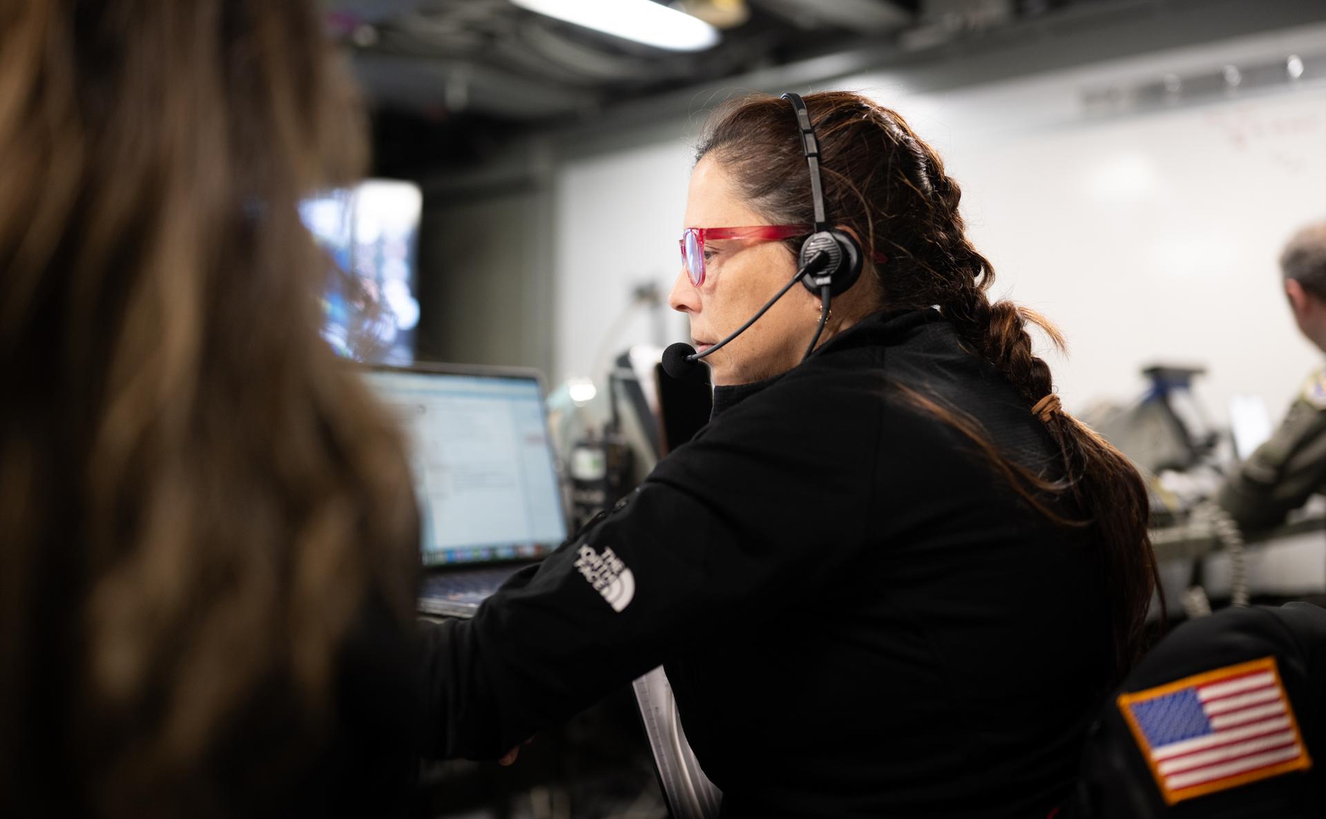 Lilian Villarreal, Artemis II landing and recovery director, is seen alongside other NASA and U.S. military recovery team members as they work inside the Landing Force Operations Center onboard USS John P. Murtha monitoring the recovery of NASA’s Orion spacecraft with Artemis II crewmembers NASA astronauts Reid Wiseman, commander; Victor Glover, pilot; Christina Koch, mission specialist; and CSA (Canadian Space Agency) astronaut Jeremy Hansen, mission specialist aboard in the Pacific Ocean off the coast of California, Friday, April 10, 2026. NASA’s Artemis II mission took Wiseman, Glover, Koch, and Hansen on a 10-day journey around the Moon and back to Earth. Following a splashdown at 5:07 p.m. PDT (8:07 p.m. EDT), NASA and U.S. military teams worked to bring the crewmembers and Orion spacecraft aboard USS John P. Murtha.  Photo Credit: (NASA/Joel Kowsky)