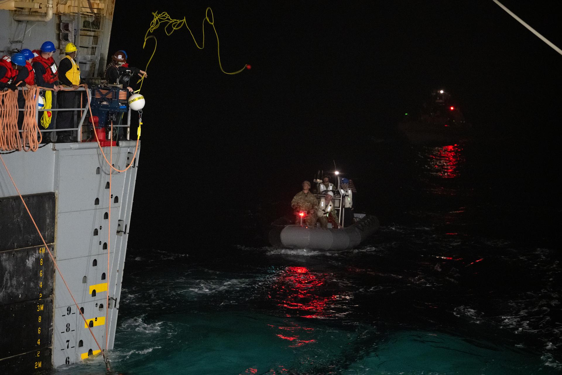 U.S. Navy personnel work alongside NASA’s Landing and Recovery team to connect lines to the agency’s Orion spacecraft is seen as they work to recover the spacecraft into the well deck of USS John P. Murtha in the Pacific Ocean off the coast of California, Saturday, April 11, 2026. NASA’s Artemis II mission, which took NASA astronauts Reid Wiseman, commander; Victor Glover, pilot; Christina Koch, mission specialist; and CSA (Canadian Space Agency) astronaut Jeremy Hansen, mission specialist on a nearly 10-day journey around the Moon and back to Earth, splashed down at 5:07 p.m. PDT (8:07 p.m. EDT).  Photo Credit: (NASA/Joel Kowsky)