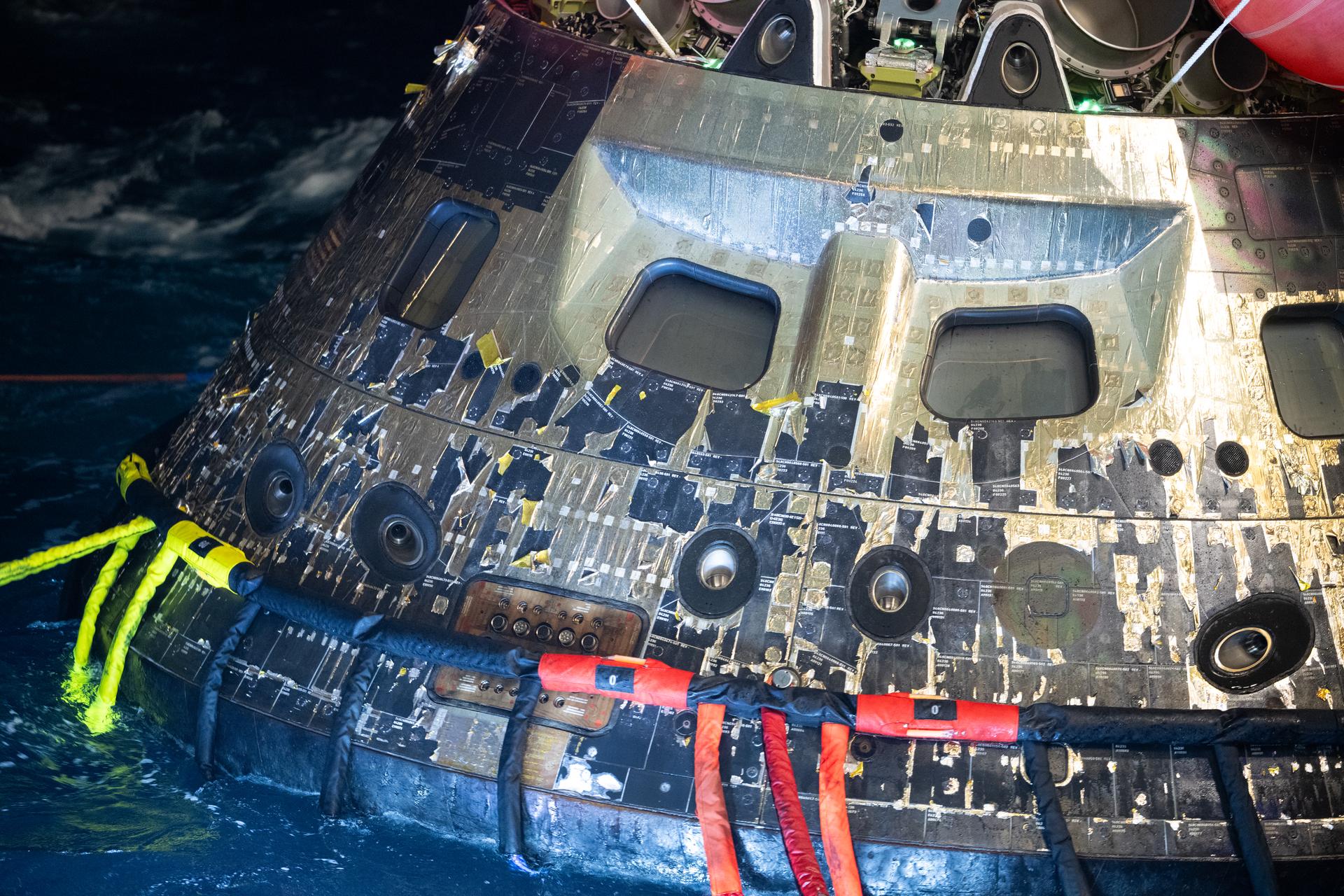 NASA’s Orion spacecraft is seen as the agency’s Landing and Recovery team, along with U.S. Navy personnel work to recover the spacecraft into the well deck of USS John P. Murtha in the Pacific Ocean off the coast of California, Saturday, April 11, 2026. NASA’s Artemis II mission, which took NASA astronauts Reid Wiseman, commander; Victor Glover, pilot; Christina Koch, mission specialist; and CSA (Canadian Space Agency) astronaut Jeremy Hansen, mission specialist on a nearly 10-day journey around the Moon and back to Earth, splashed down at 5:07 p.m. PDT (8:07 p.m. EDT).  Photo Credit: (NASA/Joel Kowsky)