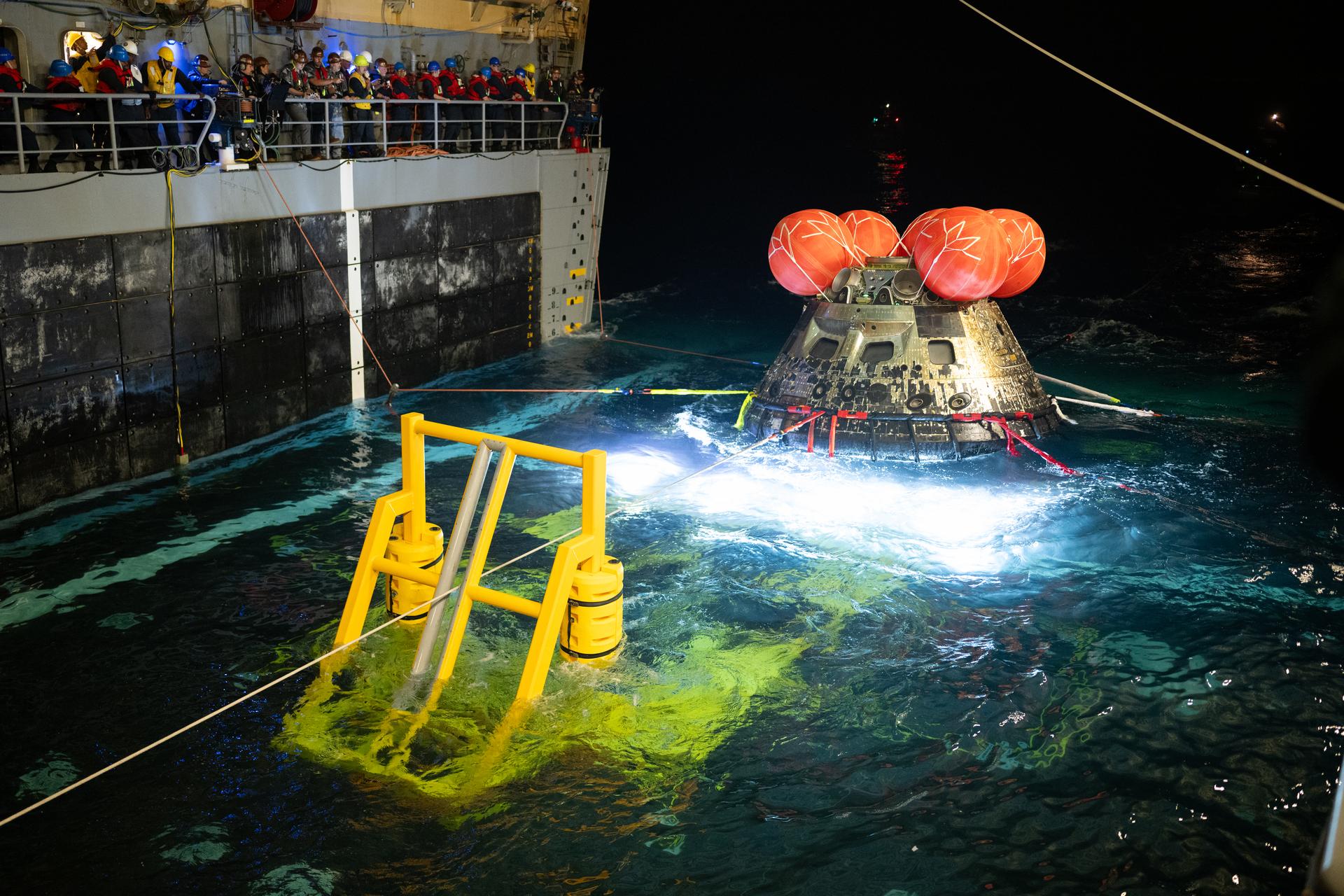 3]NASA’s Orion spacecraft is seen as the agency’s Landing and Recovery team, along with U.S. Navy personnel work to recover...