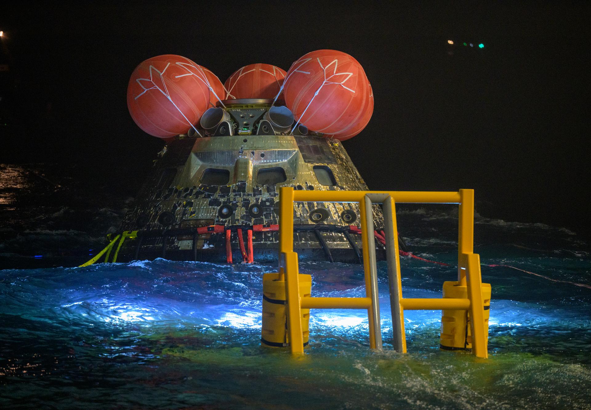 NASA’s Orion spacecraft is seen as the agency’s Landing and Recovery team, along with U.S. Navy personnel work to recover the spacecraft into the well deck of USS John P. Murtha in the Pacific Ocean off the coast of California, Saturday, April 11, 2026. NASA’s Artemis II mission, which took NASA astronauts Reid Wiseman, commander; Victor Glover, pilot; Christina Koch, mission specialist; and CSA (Canadian Space Agency) astronaut Jeremy Hansen, mission specialist on a 10-day journey around the Moon and back to Earth, splashed down at at 5:07 p.m. PDT (8:07 p.m. EDT).  Photo Credit: (NASA/Bill Ingalls)