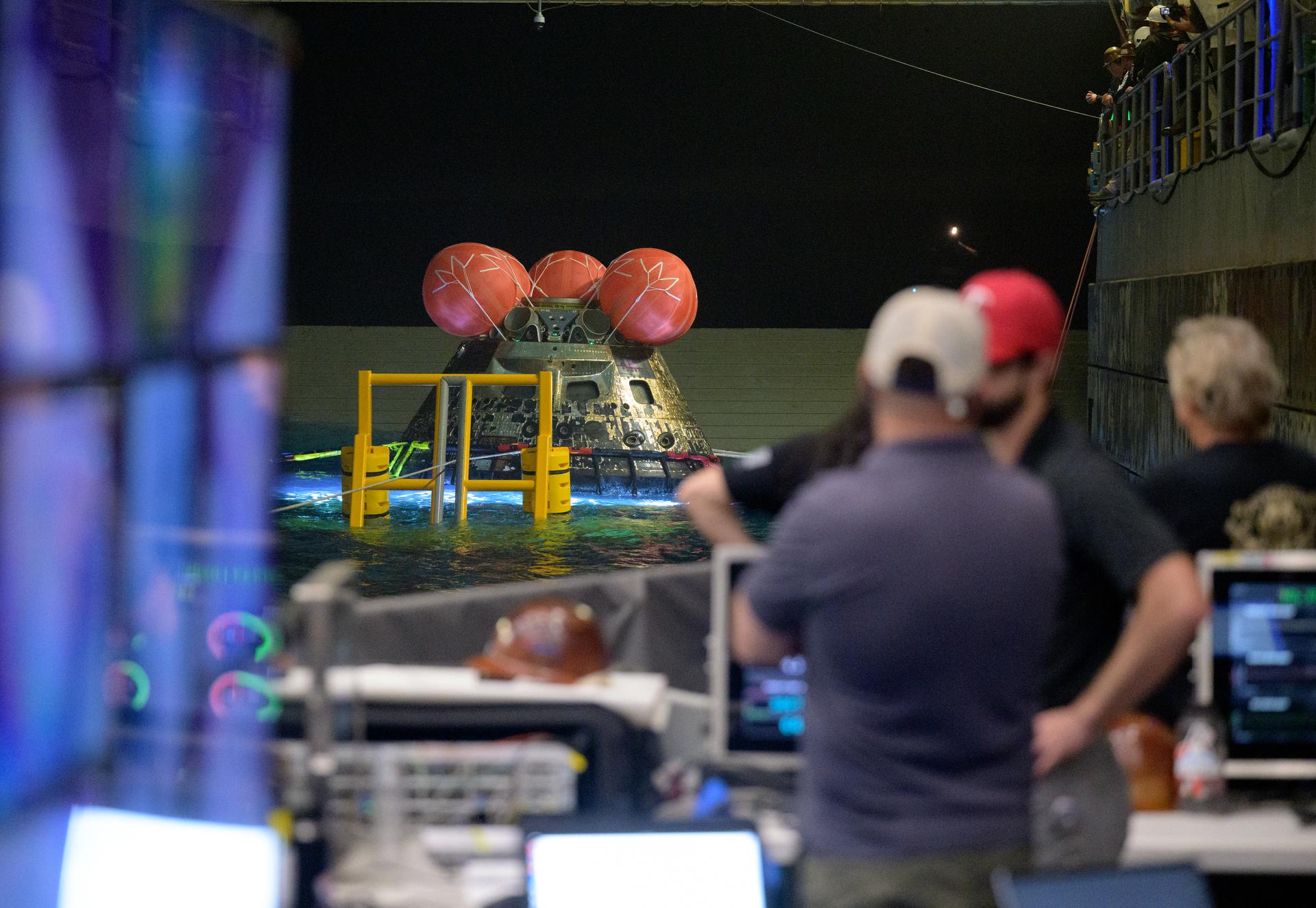 NASA’s Orion spacecraft is seen as the agency’s Landing and Recovery team, along with U.S. Navy personnel work to recover the spacecraft into the well deck of USS John P. Murtha in the Pacific Ocean off the coast of California, Saturday, April 11, 2026. NASA’s Artemis II mission, which took NASA astronauts Reid Wiseman, commander; Victor Glover, pilot; Christina Koch, mission specialist; and CSA (Canadian Space Agency) astronaut Jeremy Hansen, mission specialist on a 10-day journey around the Moon and back to Earth, splashed down at at 5:07 p.m. PDT (8:07 p.m. EDT).  Photo Credit: (NASA/Bill Ingalls)