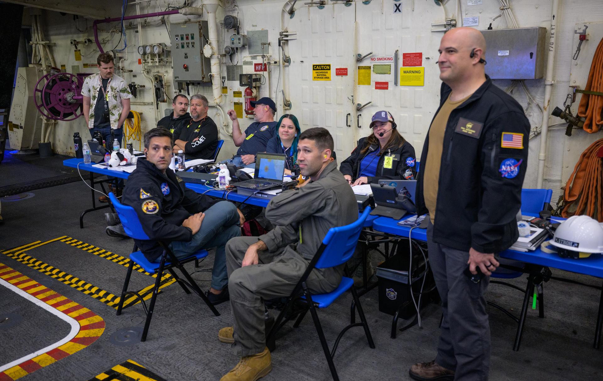 NASA’s Landing and Recovery team, along with U.S. Navy personnel work to recover the spacecraft into the well deck of USS John P. Murtha in the Pacific Ocean off the coast of California, Saturday, April 11, 2026. NASA’s Artemis II mission, which took NASA astronauts Reid Wiseman, commander; Victor Glover, pilot; Christina Koch, mission specialist; and CSA (Canadian Space Agency) astronaut Jeremy Hansen, mission specialist on a 10-day journey around the Moon and back to Earth, splashed down at at 5:07 p.m. PDT (8:07 p.m. EDT).  Photo Credit: (NASA/Bill Ingalls)