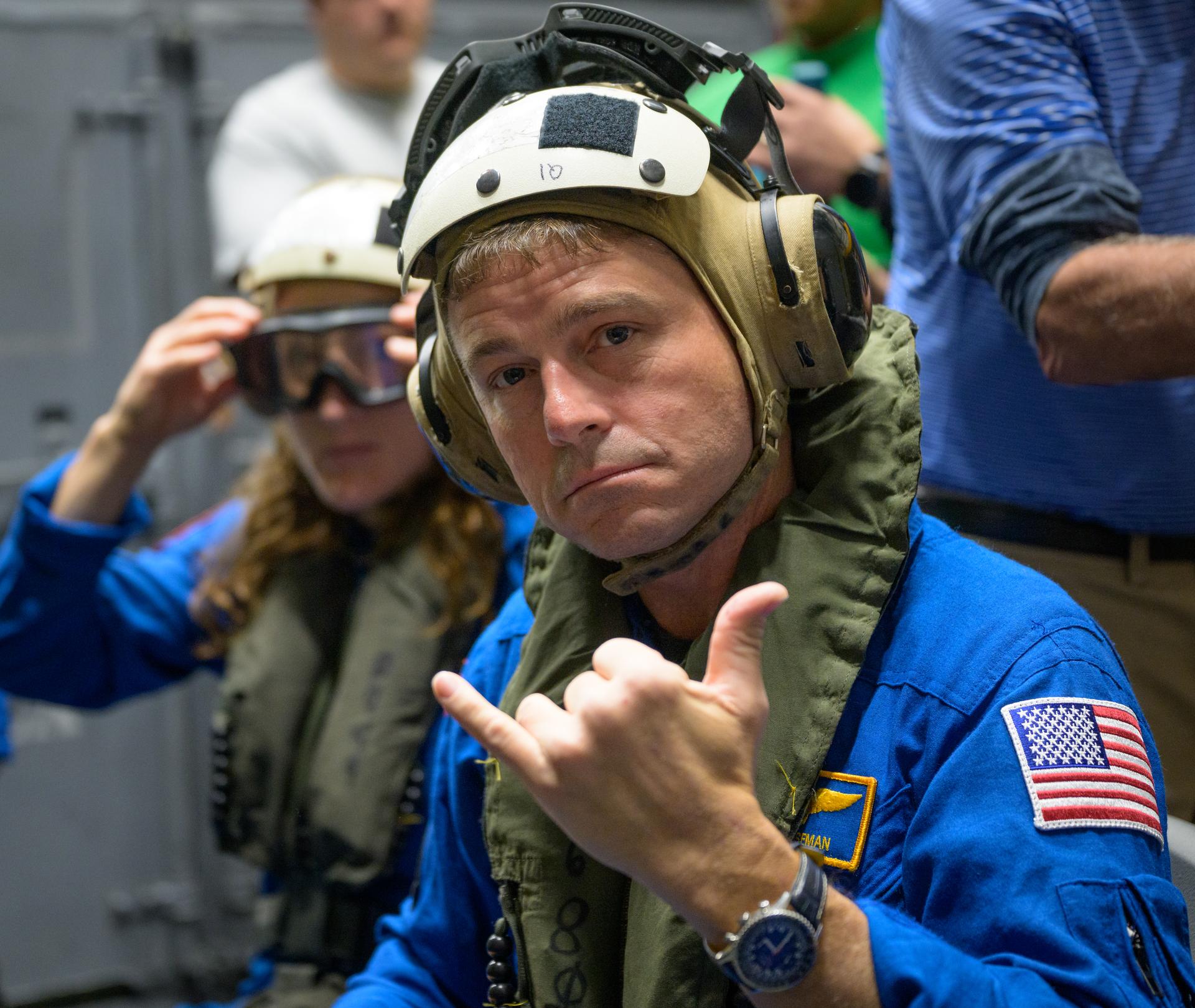 NASA astronaut Reid Wiseman, commander of the Artemis II mission gives a shaka hand gesture as he and NASA astronaut...