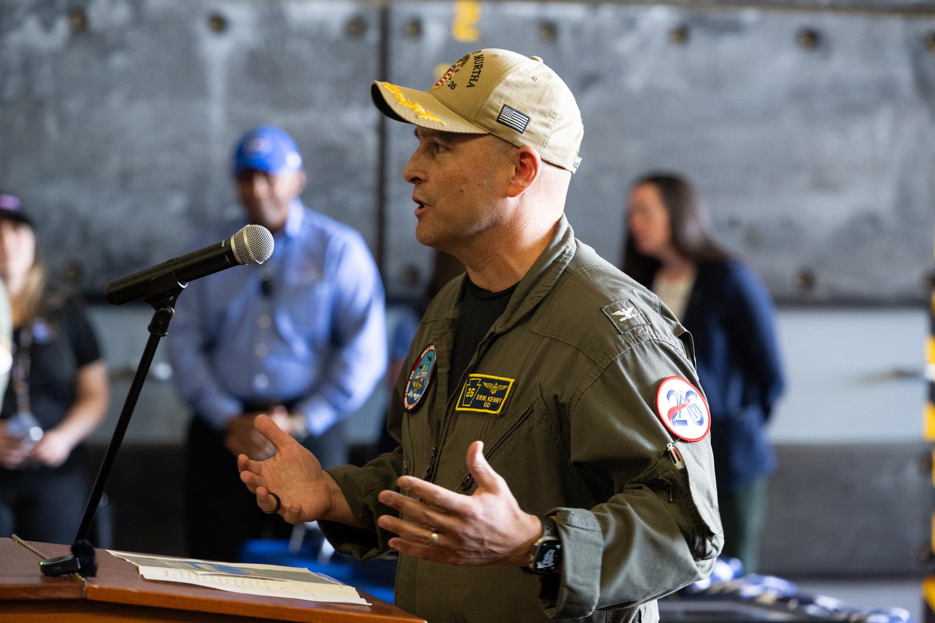 Capt, Erik Kenny, commanding officer of USS John P. Murtha speaks to the ships crew, NASA Landing and Recovery teams, and the agency’s U.S. military recovery partners in the well deck of John P. Murtha, Saturday, April 11, 2026, at Naval Base San Diego after supporting recovery operations for NASA’s Artemis II mission. The agency’s Artemis II mission, which took NASA astronauts Reid Wiseman, commander; Victor Glover, pilot; Christina Koch, mission specialist; and CSA (Canadian Space Agency) astronaut Jeremy Hansen, mission specialist on a nearly 10-day journey around the Moon and back to Earth, splashed down at 5:07 p.m. PDT (8:07 p.m. EDT) on April 10 in the Pacific Ocean off the coast of California.  Photo Credit: (NASA/Joel Kowsky)