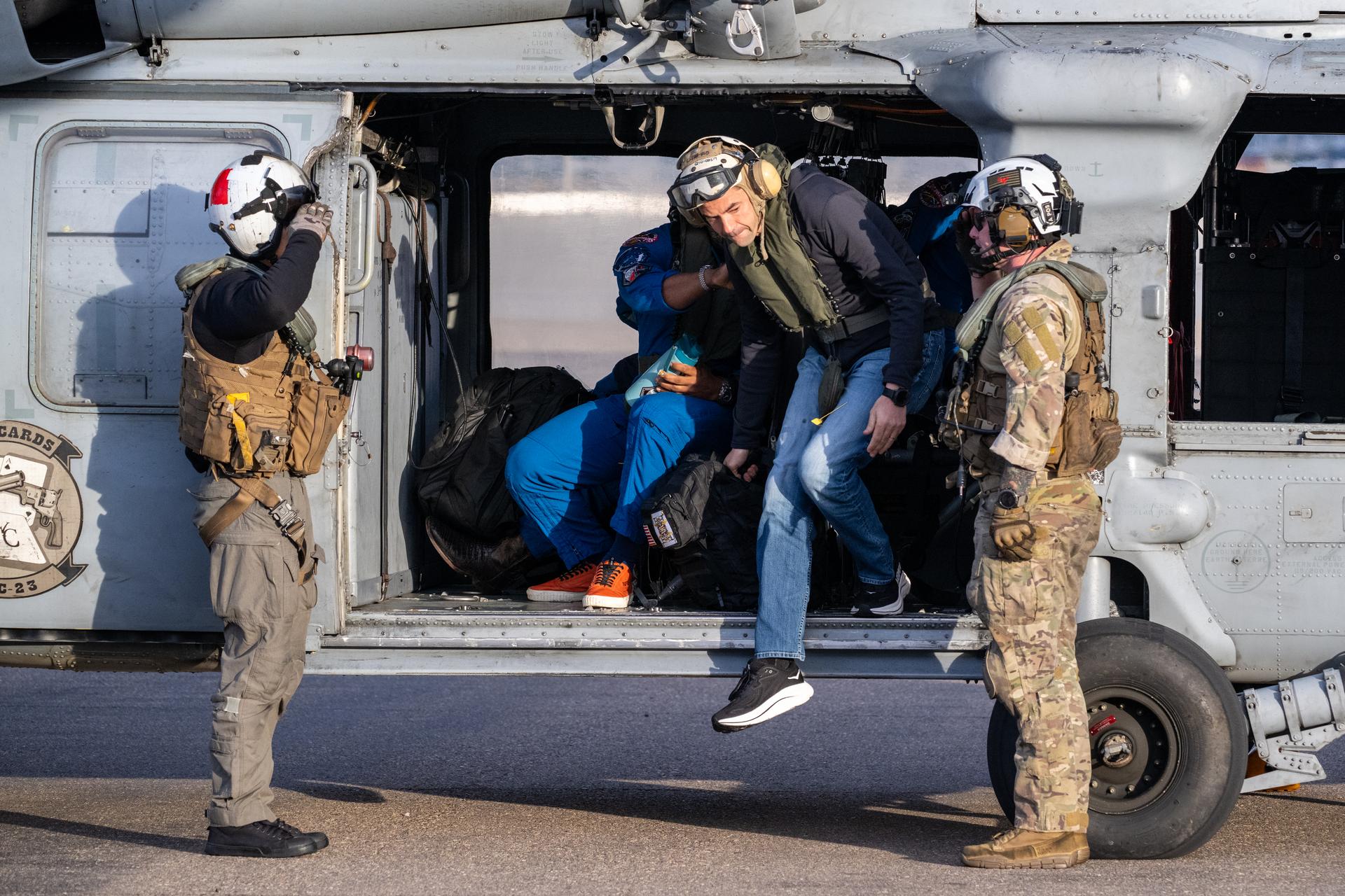 NASA Administrator Jared Isaacman disembarks a Navy MH-60 Seahawk from Helicopter Sea Combat Squadron (HSC) 23 after Artemis II NASA astronauts Reid Wiseman, commander; Victor Glover, pilot; Christina Koch, mission specialist; and CSA (Canadian Space Agency) astronaut Jeremy Hansen, mission specialist were flown from USS John P. Murtha to Naval Air Station North Island, Saturday, April 11, 2026, following a splashdown in the Pacific Ocean off the coast of California at 5:07 p.m. PDT (8:07 p.m. EDT) on April 10. NASA’s Artemis II mission took the quartet on a nearly ten day journey around the Moon and back to Earth. Photo Credit: (NASA/Keegan Barber)