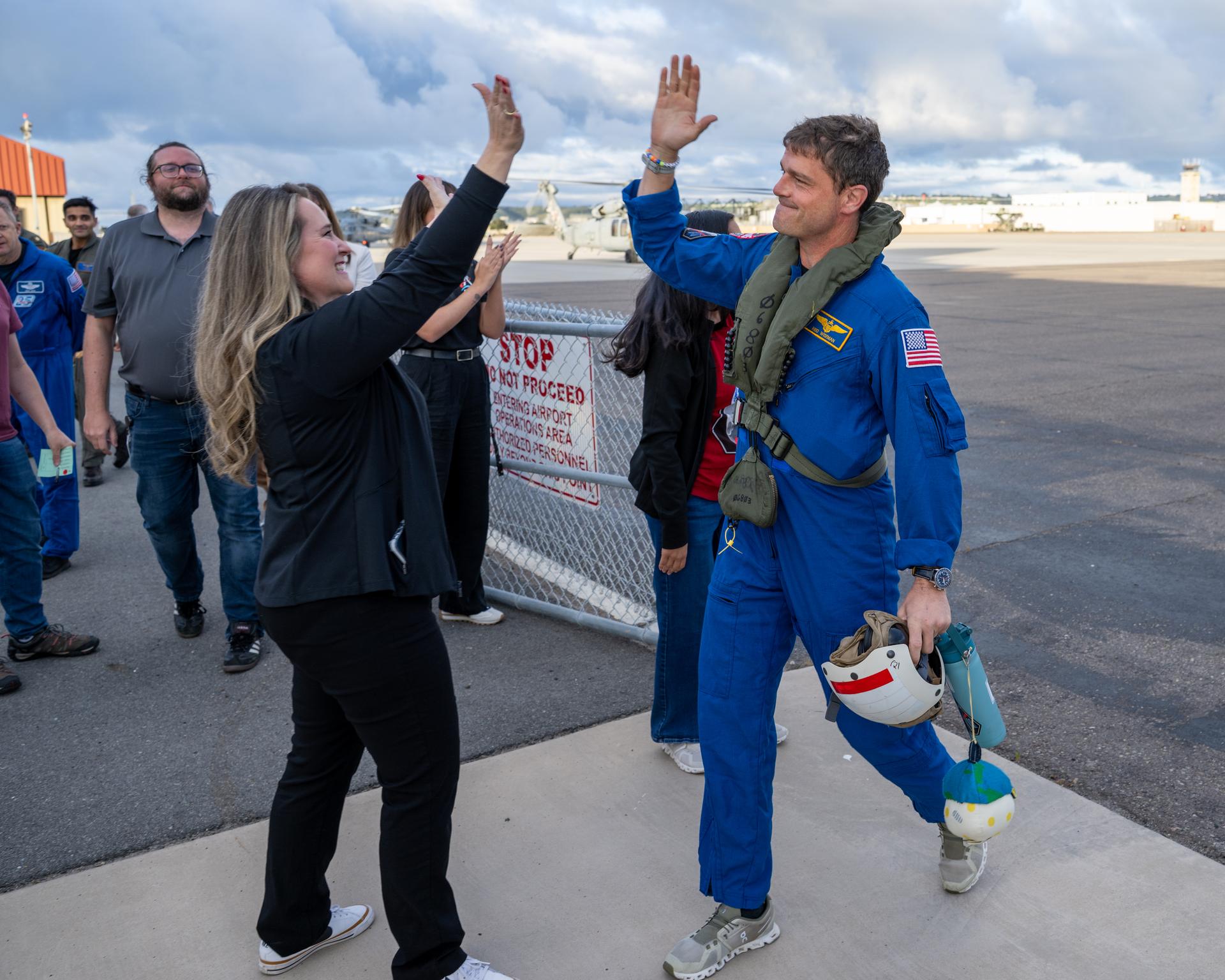 Artemis II NASA astronaut Reid Wiseman, commander, greets NASA team members after being flown from USS John P. Murtha to Naval Air Station North Island on Navy MH-60 Seahawks from Helicopter Sea Combat Squadron (HSC) 23, Saturday, April 11, 2026, following a splashdown in the Pacific Ocean off the coast of California at 5:07 p.m. PDT (8:07 p.m. EDT) on April 10. NASA’s Artemis II mission took NASA astronauts Reid Wiseman, commander; Victor Glover, pilot; Christina Koch, mission specialist; and CSA (Canadian Space Agency) astronaut Jeremy Hansen, mission specialist on a nearly ten day journey around the Moon and back to Earth. Photo Credit: (NASA/Keegan Barber)