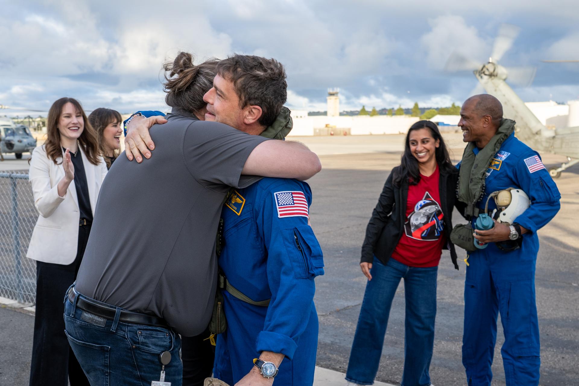 Artemis II NASA astronaut Reid Wiseman, commander, and Victor Glover, pilot, greet NASA team members after being flown from USS John P. Murtha to Naval Air Station North Island on Navy MH-60 Seahawks from Helicopter Sea Combat Squadron (HSC) 23, Saturday, April 11, 2026, following a splashdown in the Pacific Ocean off the coast of California at 5:07 p.m. PDT (8:07 p.m. EDT) on April 10. NASA’s Artemis II mission took NASA astronauts Reid Wiseman, commander; Victor Glover, pilot; Christina Koch, mission specialist; and CSA (Canadian Space Agency) astronaut Jeremy Hansen, mission specialist on a nearly ten day journey around the Moon and back to Earth. Photo Credit: (NASA/Keegan Barber)