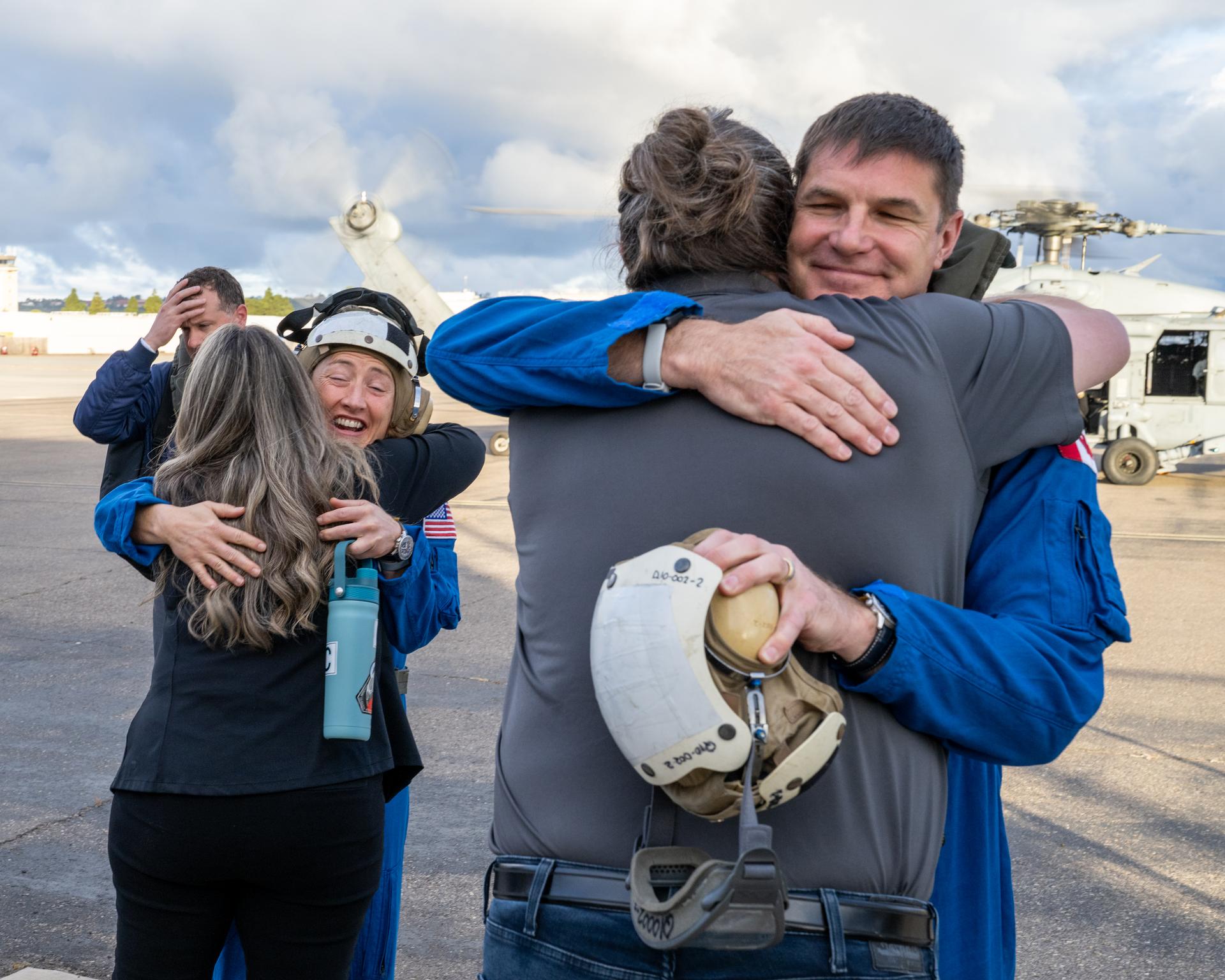 Artemis II NASA astronaut Christina Koch, mission specialist, and CSA (Canadian Space Agency) astronaut Jeremy Hansen, greet NASA team members after being flown from USS John P. Murtha to Naval Air Station North Island on Navy MH-60 Seahawks from Helicopter Sea Combat Squadron (HSC) 23, Saturday, April 11, 2026, following a splashdown in the Pacific Ocean off the coast of California at 5:07 p.m. PDT (8:07 p.m. EDT) on April 10. NASA’s Artemis II mission took NASA astronauts Reid Wiseman, commander; Victor Glover, pilot; Christina Koch, mission specialist; and CSA (Canadian Space Agency) astronaut Jeremy Hansen, mission specialist on a nearly ten day journey around the Moon and back to Earth. Photo Credit: (NASA/Keegan Barber)