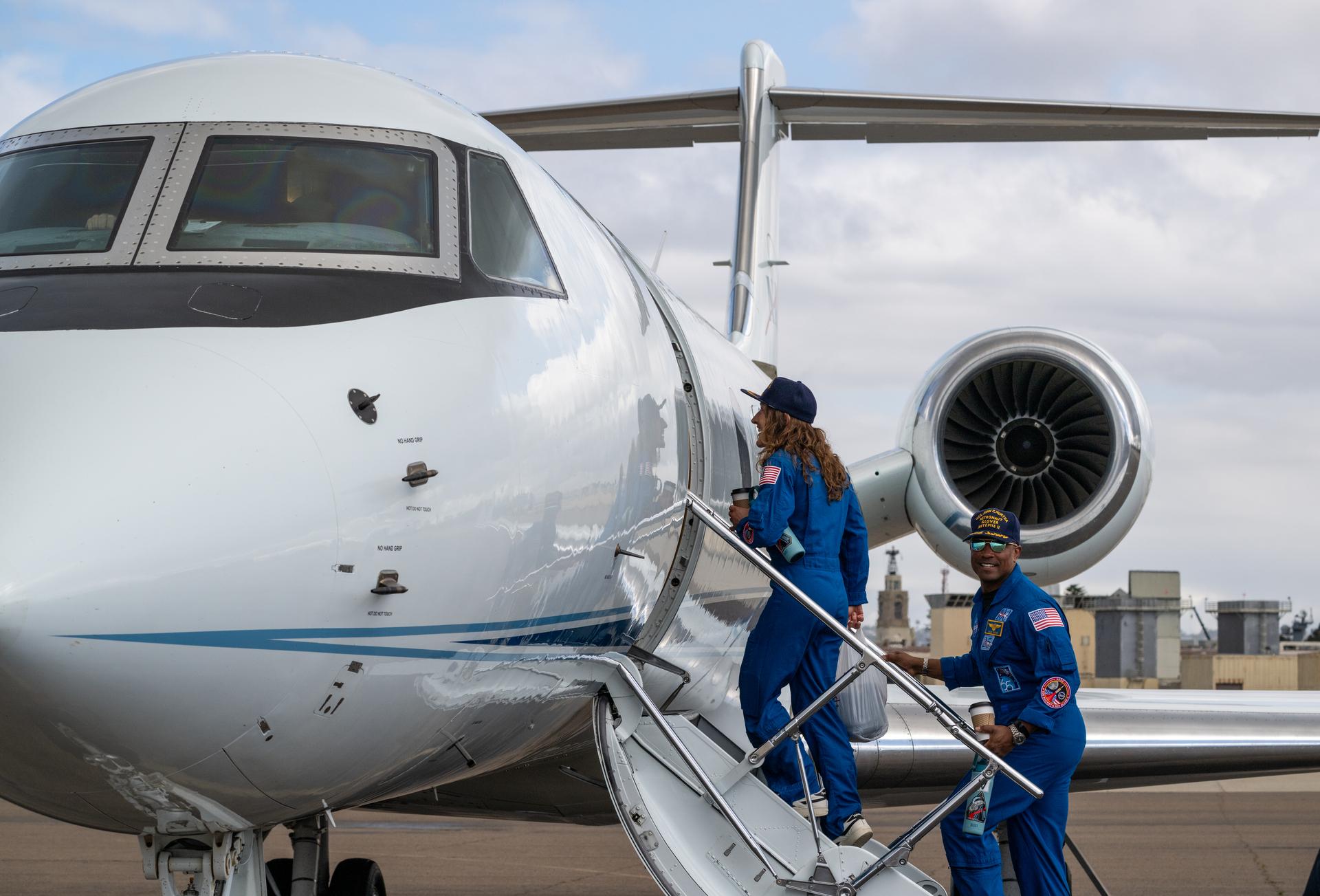 Artemis II NASA astronauts Victor Glover, pilot and Christina Koch, mission specialist, board the NASA Gulfstream V Saturday, April 11, 2026, at Naval Air Station North Island in San Diego, Calif. NASA’s Artemis II mission took NASA astronauts Reid Wiseman, commander; Victor Glover, pilot; Christina Koch, mission specialist; and CSA (Canadian Space Agency) astronaut Jeremy Hansen, mission specialist on a nearly ten day journey around the Moon and back to Earth. Photo Credit: (NASA/Keegan Barber)