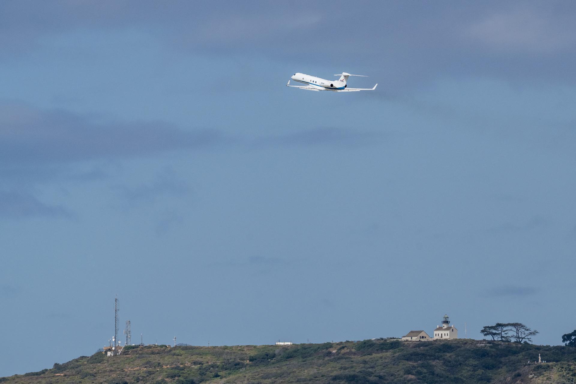 The NASA Gulfstream V carrying NASA astronauts Reid Wiseman, commander; Victor Glover, pilot; Christina Koch, mission specialist; and CSA (Canadian Space Agency) astronaut Jeremy Hansen, mission specialist is seen shortly after takeoff from Naval Air Station North Island in San Diego, Calif. Saturday, April 11, 2026, en route to Houston, Texas. NASA’s Artemis II mission took the quartet on a nearly ten day journey around the Moon and back to Earth. Photo Credit: (NASA/Keegan Barber)