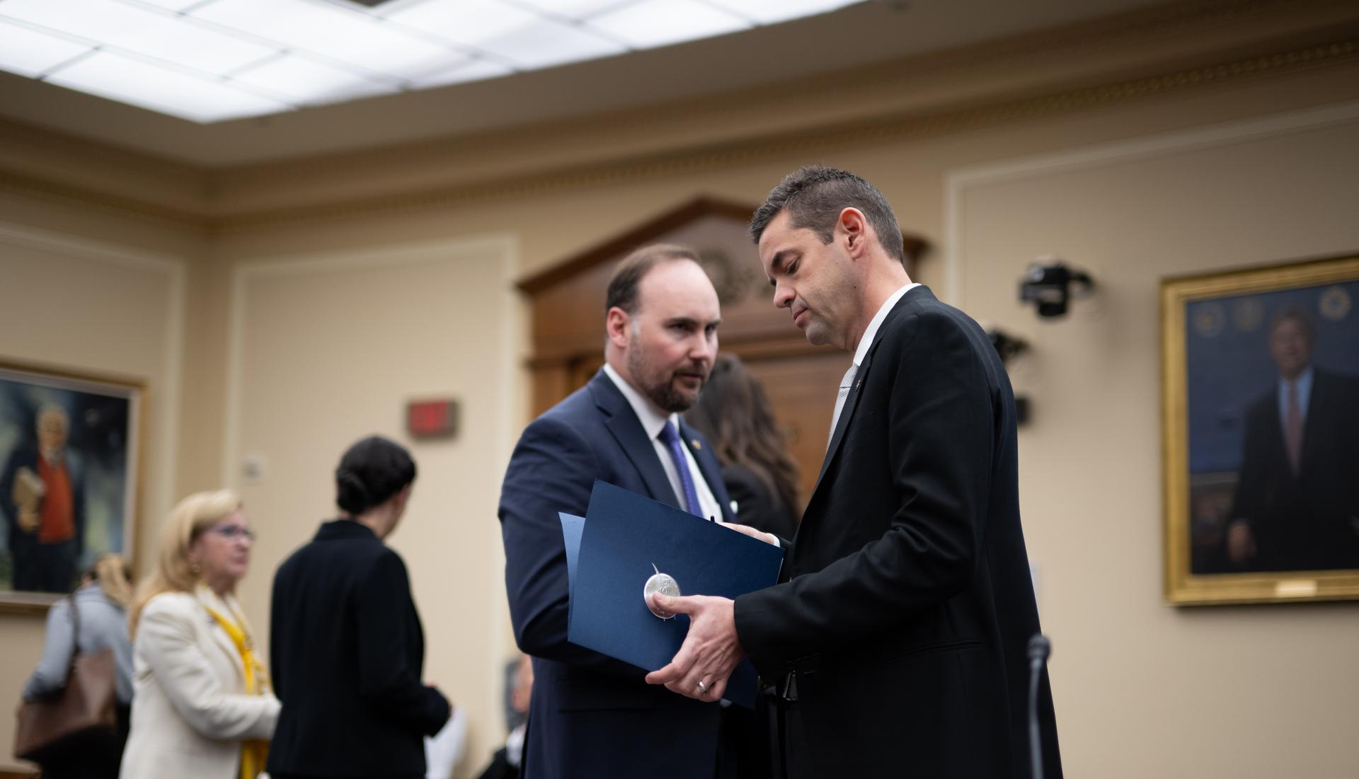 NASA Administrator Jared Isaacman, right, speaks with Joel Graham, associate administrator for NASA's Office of Legislative and Intergovernmental Affairs at the beginning of a recess during a House Committee on Science, Space, and Technology hearing regarding the President’s Fiscal Year 2027 budget request for the agency, Wednesday, April 22, 2026, at the Rayburn House Office Building in Washington.  Photo Credit: (NASA/Joel Kowsky)