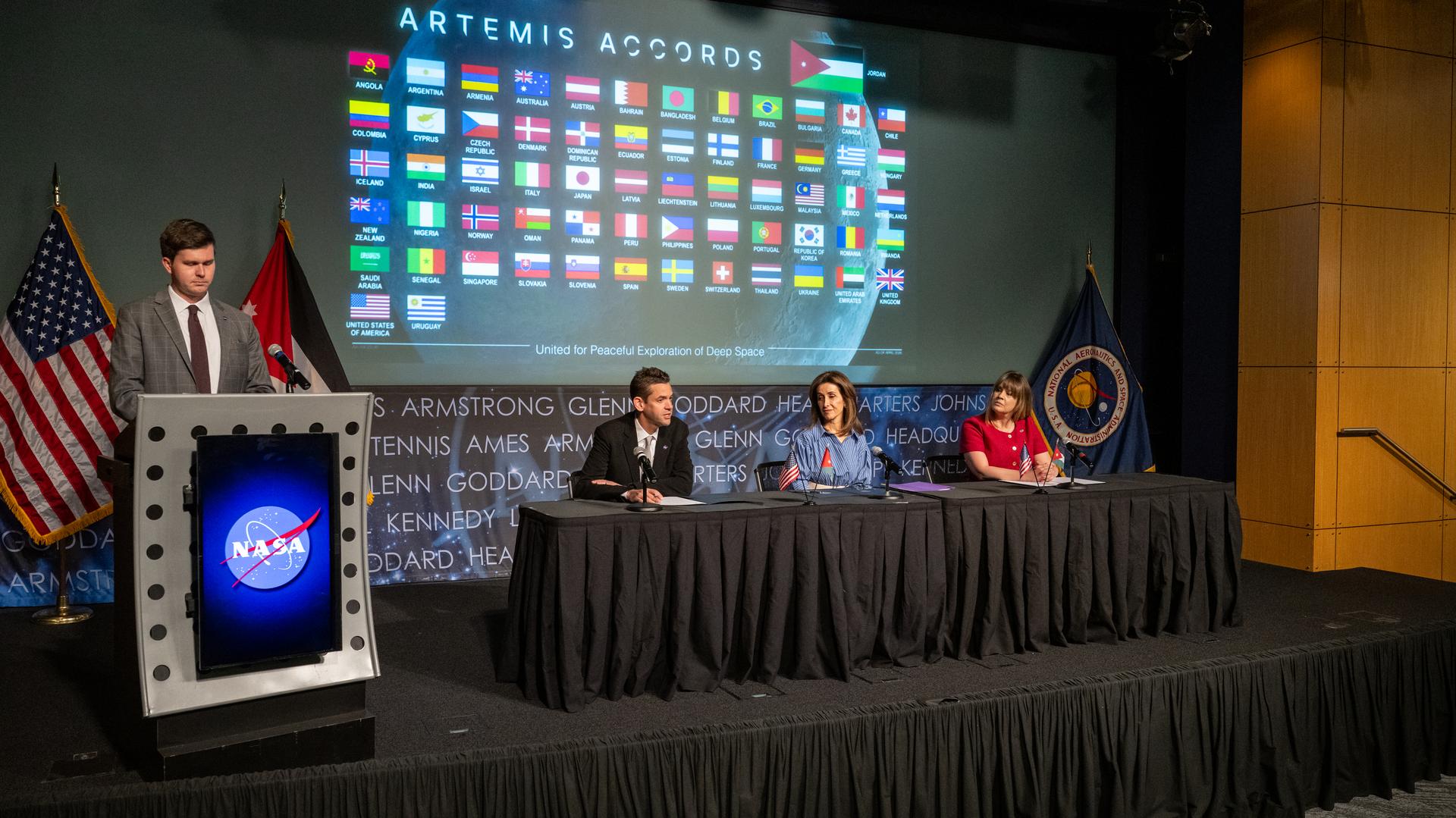 NASA Administrator Jared Isaacman, third from right, delivers remarks during an Artemis Accords signing ceremony alongside Ambassador of Jordan to the United States Dina Kawar, second from right, and Acting Principal Deputy Assistant Secretary of State for Oceans and International Environmental and Scientific Affairs Ruth Perry, right, Thursday, April 23, 2026, at the Mary W. Jackson NASA Headquarters building in Washington. The Hashemite Kingdom of Jordan is the 63rd country to sign the Artemis Accords, which establish a practical set of principles to guide space exploration cooperation among nations participating in NASA’s Artemis program. Photo Credit: (NASA/Keegan Barber)