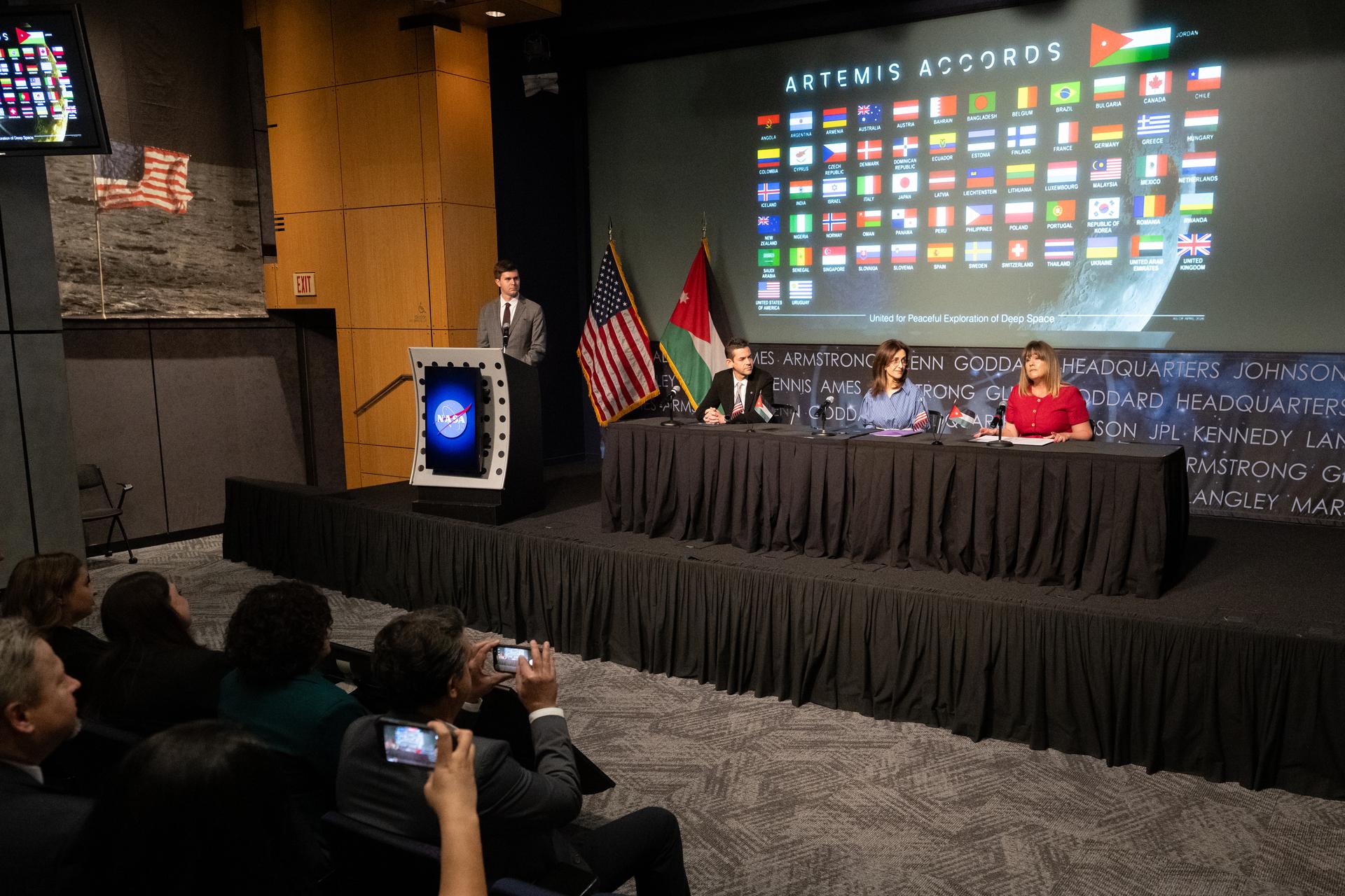 Acting Principal Deputy Assistant Secretary of State for Oceans and International Environmental and Scientific Affairs Ruth Perry, right, delivers remarks during an Artemis Accords signing ceremony alongside Ambassador of Jordan to the United States Dina Kawar, second from right, and NASA Administrator Jared Isaacman, third from right, Thursday, April 23, 2026, at the Mary W. Jackson NASA Headquarters building in Washington. The Hashemite Kingdom of Jordan is the 63rd country to sign the Artemis Accords, which establish a practical set of principles to guide space exploration cooperation among nations participating in NASA’s Artemis program. Photo Credit: (NASA/Keegan Barber)