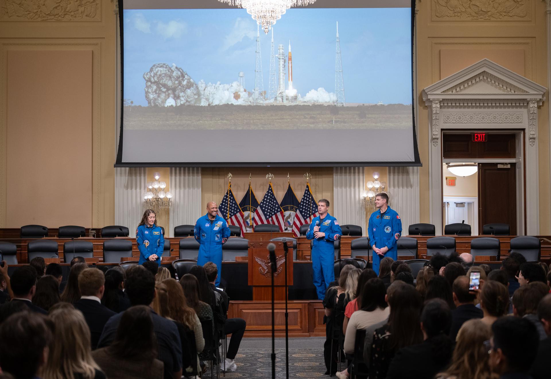 NASA astronauts Christina Koch, mission specialist, left; Victor Glover, pilot, second from left; Reid Wiseman, commander, second from right; and CSA (Canadian Space Agency) astronaut Jeremy Hansen, mission specialist, right, are seen as they speak with congressional staff, Tuesday, May 12, 2026, in the Cannon House Office Building, in Washington. NASA’s Artemis II mission took Wiseman, Glover, Koch, and Hansen on a nearly 10-day journey around the Moon and back to Earth in April 2026. Photo Credit: (NASA/Joel Kowsky)