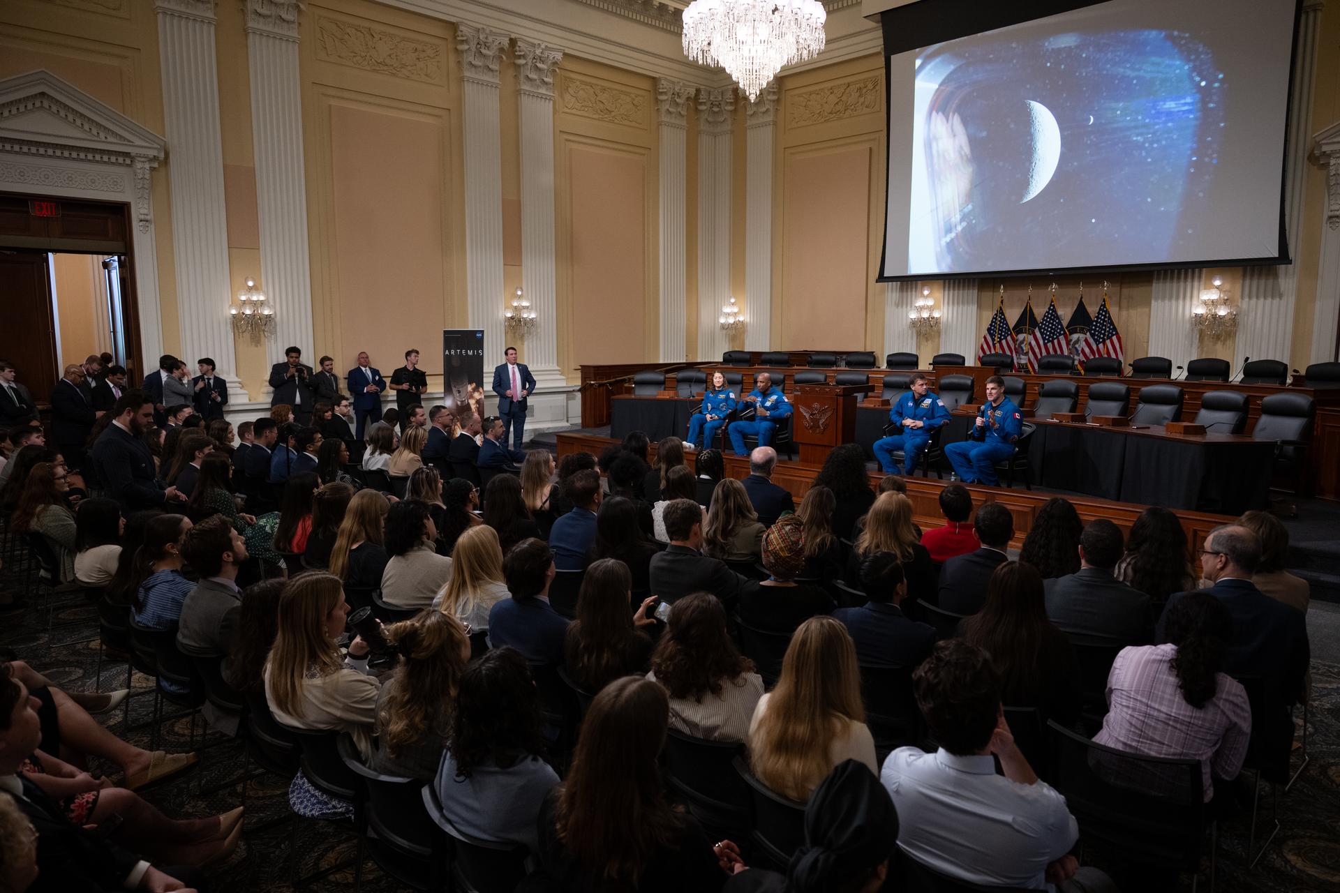 NASA astronauts Christina Koch, mission specialist, left; Victor Glover, pilot, second from left; Reid Wiseman, commander, second from right; and CSA (Canadian Space Agency) astronaut Jeremy Hansen, mission specialist, right, are seen as they speak with congressional staff, Tuesday, May 12, 2026, in the Cannon House Office Building, in Washington. NASA’s Artemis II mission took Wiseman, Glover, Koch, and Hansen on a nearly 10-day journey around the Moon and back to Earth in April 2026. Photo Credit: (NASA/Joel Kowsky)