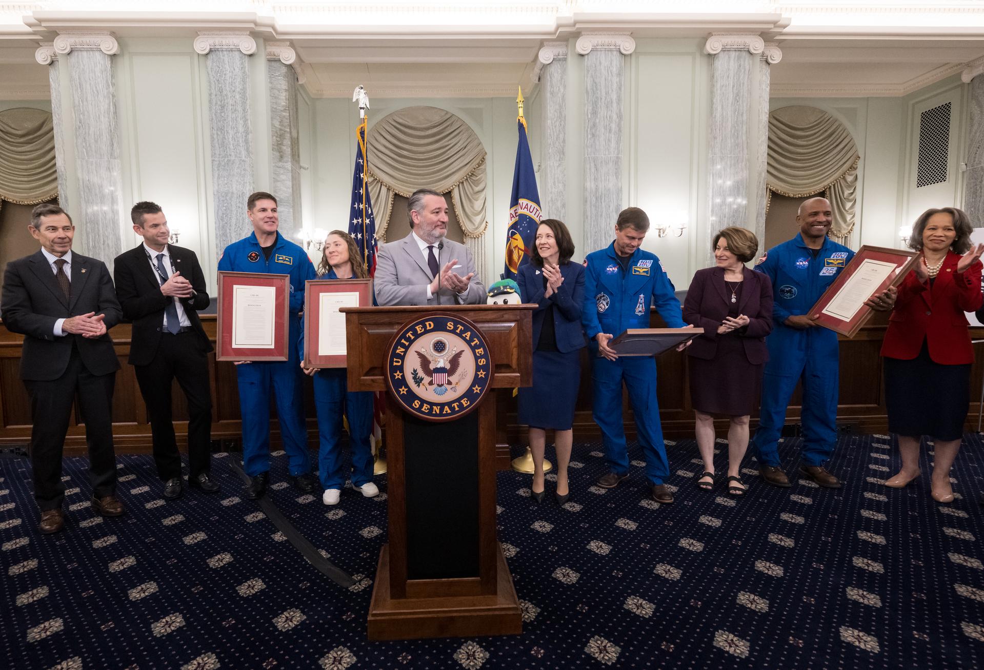 U.S. Senator Ted Cruz (R-Texas) announces Senate Resolution 695 of the 119th Congress that commemorates the success of the Artemis II mission and presents them to the Artemis II crew, NASA astronauts Reid Wiseman, commander; Victor Glover, pilot; Christina Koch, mission specialist; and CSA (Canadian Space Agency) astronaut Jeremy Hansen, mission specialist, during an event at the Russell Senate Office Building, Tuesday, May 12, 2026, in Washington. NASA’s Artemis II mission took Wiseman, Glover, Koch, and Hansen on a nearly 10-day journey around the Moon and back to Earth in April 2026. Photo Credit: (NASA/Aubrey Gemignani)