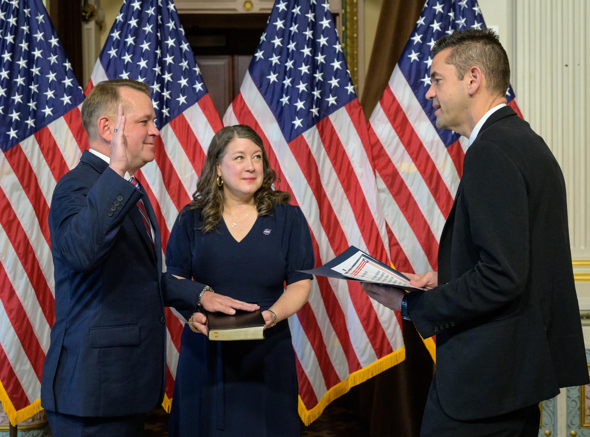 Matt Anderson, left, joined by his wife Christine, is sworn in as the 16th Deputy Administrator of NASA, by NASA Administrator Jared Isaacman, Thursday, May 21, 2026, at the Eisenhower Executive Office Building in Washington. Photo Credit: (NASA/Bill Ingalls)