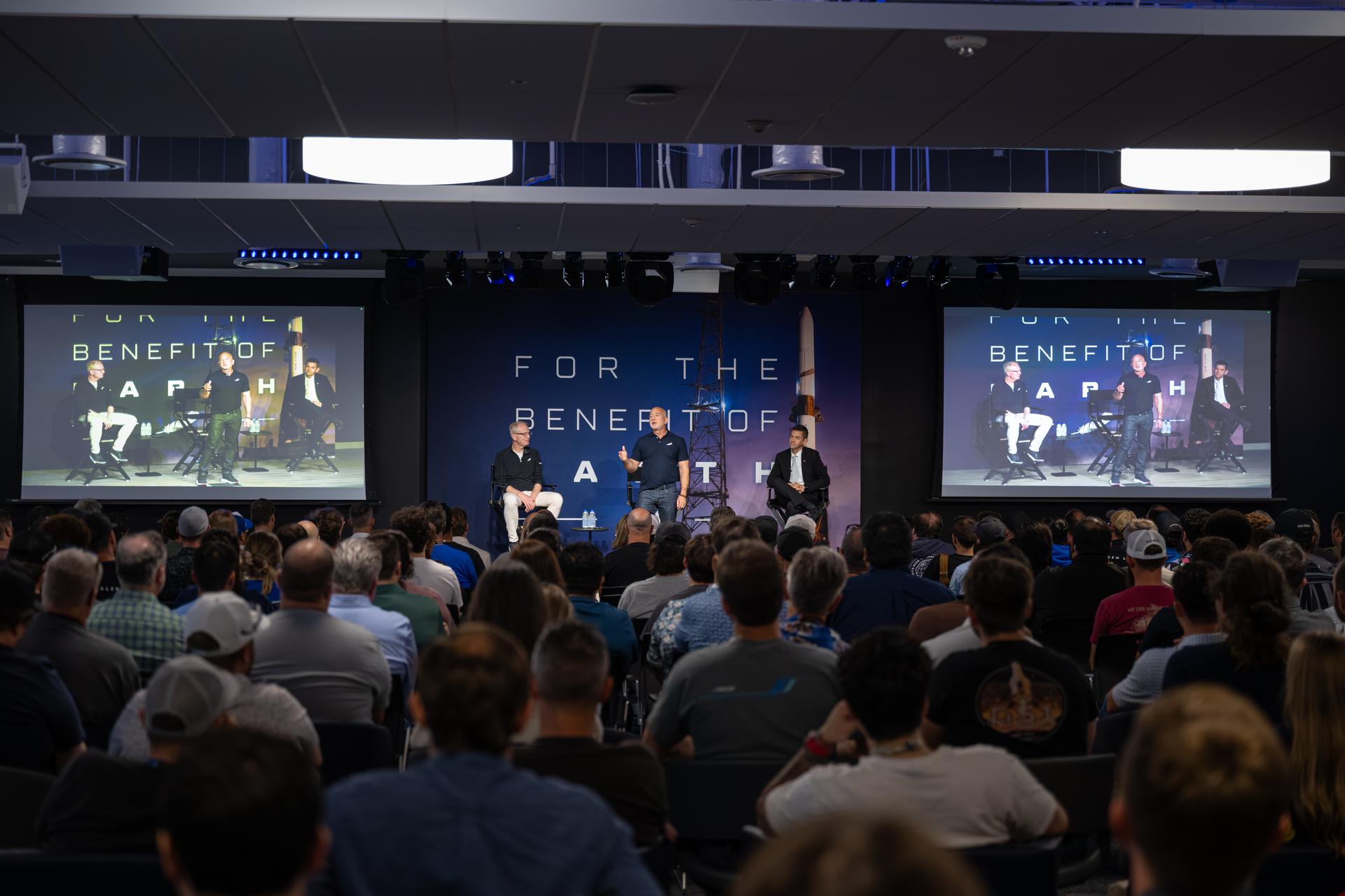 NASA Administrator Jared Isaacman, right, participates in an employee all-hands meeting alongside Dave Limp, chief executive officer, Blue Origin, left, and Jeff Bezos, founder, Blue Origin, center, Friday, May 29, 2026, at Blue Origin’s Rocket Park in Merritt Island, Fla. Photo Credit: (NASA/John Kraus)