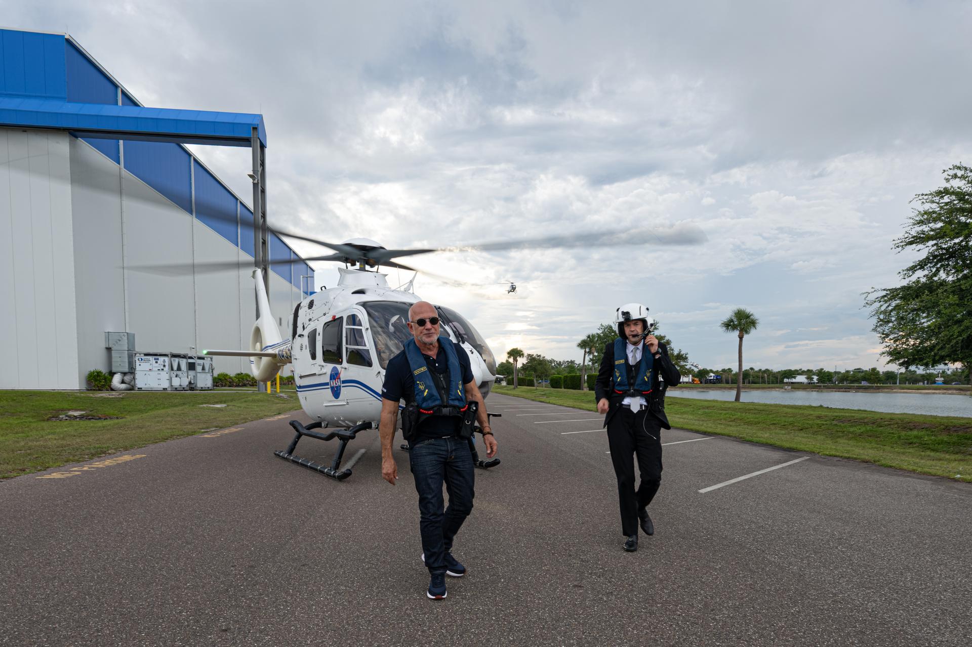 NASA Administrator Jared Isaacman, right, and Jeff Bezos, founder, Blue Origin, left, are seen following a helicopter flight, Friday, May 29, 2026, at Blue Origin’s Rocket Park in Merritt Island, Fla. The flight surveyed nearby Launch Complex 36 at Cape Canaveral Space Force Station following a New Glenn hotfire test anomaly on May 28. Photo Credit: (NASA/John Kraus)