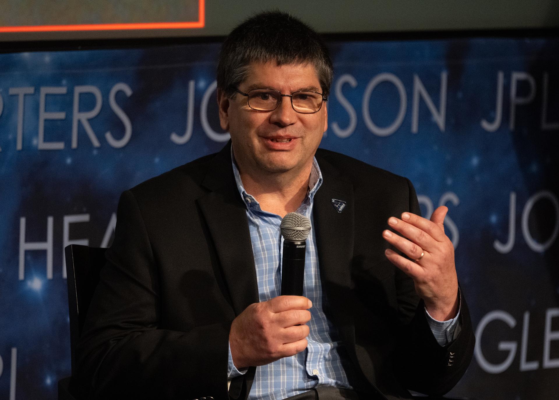 Patrick Crouse, Hubble Space Telescope project manager at NASA’s Goddard Space Flight Center, speaks on a panel with John Grunsfeld, former NASA astronaut and former associate administrator for NASA’s Science Mission Directorate, Marc Postman, head of the Science Mission office at the Space Telescope Science Institute, and Lennard Fisk, former associate administrator for NASA Space Science and Applications, about building a foundation for Hubble science during an event titled “Beyond the Deep Field: Hubble’s Legacy and the Future of Cosmic Observation,” Thursday, June 4, 2026, at the Mary W. Jackson NASA Headquarters building in Washington. Photo Credit: (NASA/Joel Kowsky)