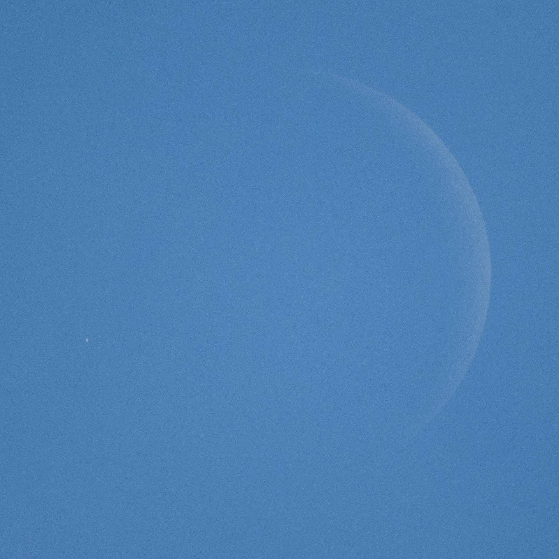 Venus is seen, during daylight, as it disappears behind the Moon, at the start of occultation, on Wednesday, June 17, 2026, from the Mary W. Jackson NASA Headquarters building in Washington. The Moon occulted, or passed in front of, Venus for the first of three time this year.  Photo Credit: (NASA/Joel Kowsky)