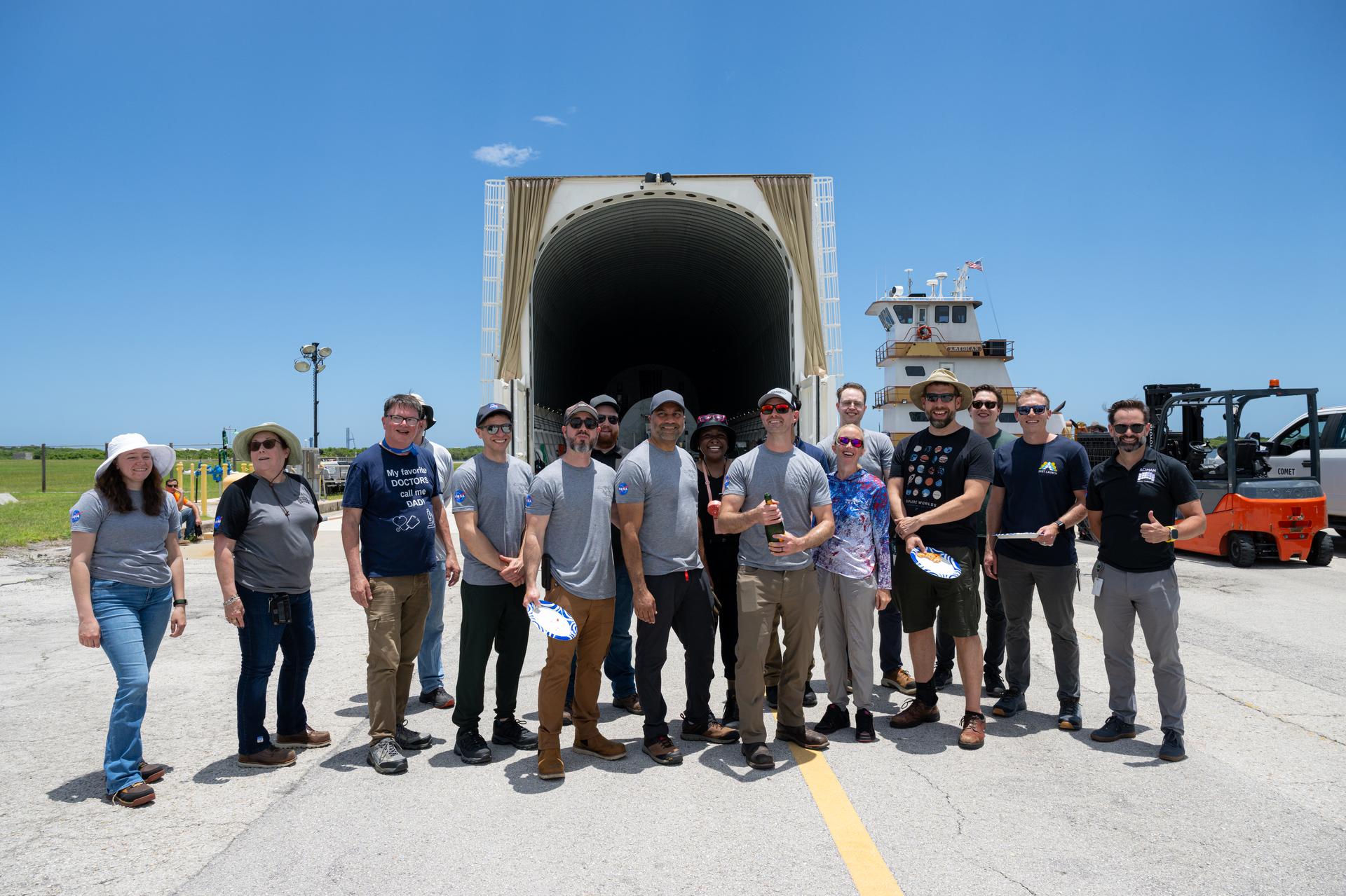 Members of the Nancy Grace Roman Space Telescope transport team pose for a photograph with NASA’s Pegasus barge, Sunday, June 21, at NASA’s Kennedy Space Center in Florida. The Pegasus barge delivered NASA’s Nancy Grace Roman Space Telescope and a weather cover for the Artemis III SLS (Space Launch System) rocket core stage to Kennedy. Photo Credit: (NASA/John Kraus)