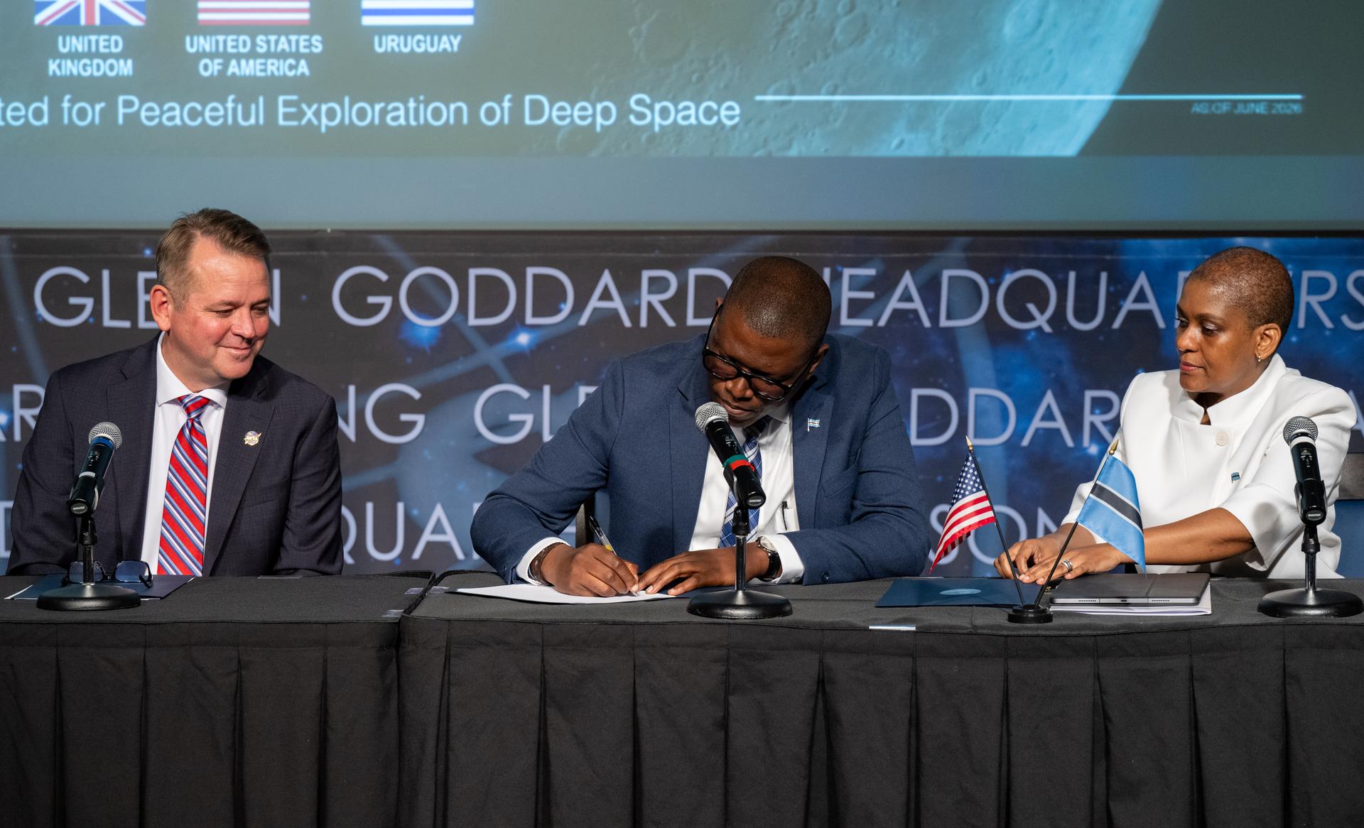 Minister of Communications and Innovation David Tshere, center, signs the Artemis Accords during a ceremony with the Republic of Botswana alongside NASA Deputy Administrator Matt Anderson, left, and Acting Ambassador of the Republic of Botswana to the United States Mabedi Ngwenya, right, Thursday, June 25, 2026, at the Mary W. Jackson NASA Headquarters building in Washington. The Republic of Botswana is the 68th country to sign the Artemis Accords, which establish a practical set of principles to guide space exploration cooperation among nations participating in NASA’s Artemis program. Photo Credit: (NASA/Keegan Barber)
