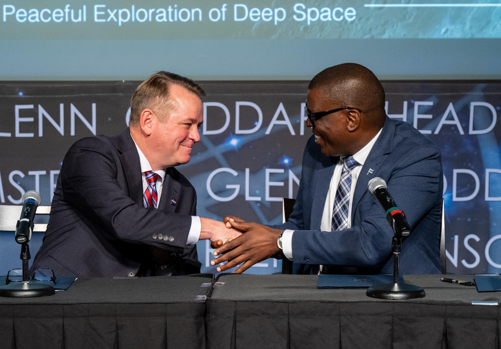 Minister of Communications and Innovation David Tshere, right, shakes hands with NASA Deputy Administrator Matt Anderson, left, after signing the Artemis Accords during a ceremony with the Republic of Botswana Thursday, June 25, 2026, at the Mary W. Jackson NASA Headquarters building in Washington. The Republic of Botswana is the 68th country to sign the Artemis Accords, which establish a practical set of principles to guide space exploration cooperation among nations participating in NASA’s Artemis program. Photo Credit: (NASA/Keegan Barber)