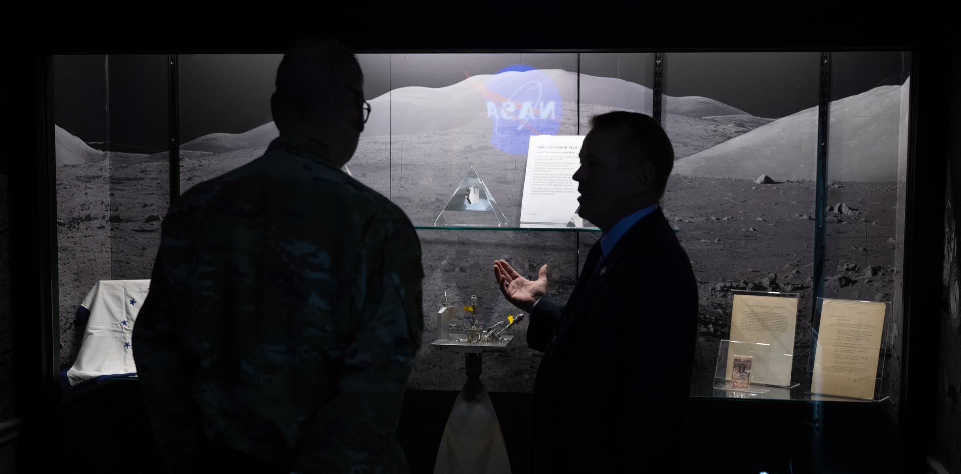 NASA Deputy Administrator Matt Anderson, right, and U.S. Air Force Lt. Gen. Luke Ahmann, Commander, Continental U.S. North American Aerospace Defense Command Region; Commander, 1st Air Force, are seen in front of lunar rocks collected during the Apollo 17 mission in 1972,  Tuesday, June 30, 2026, at the Mary W. Jackson NASA Headquarters building in Washington.  Photo Credit: (NASA/Joel Kowsky)