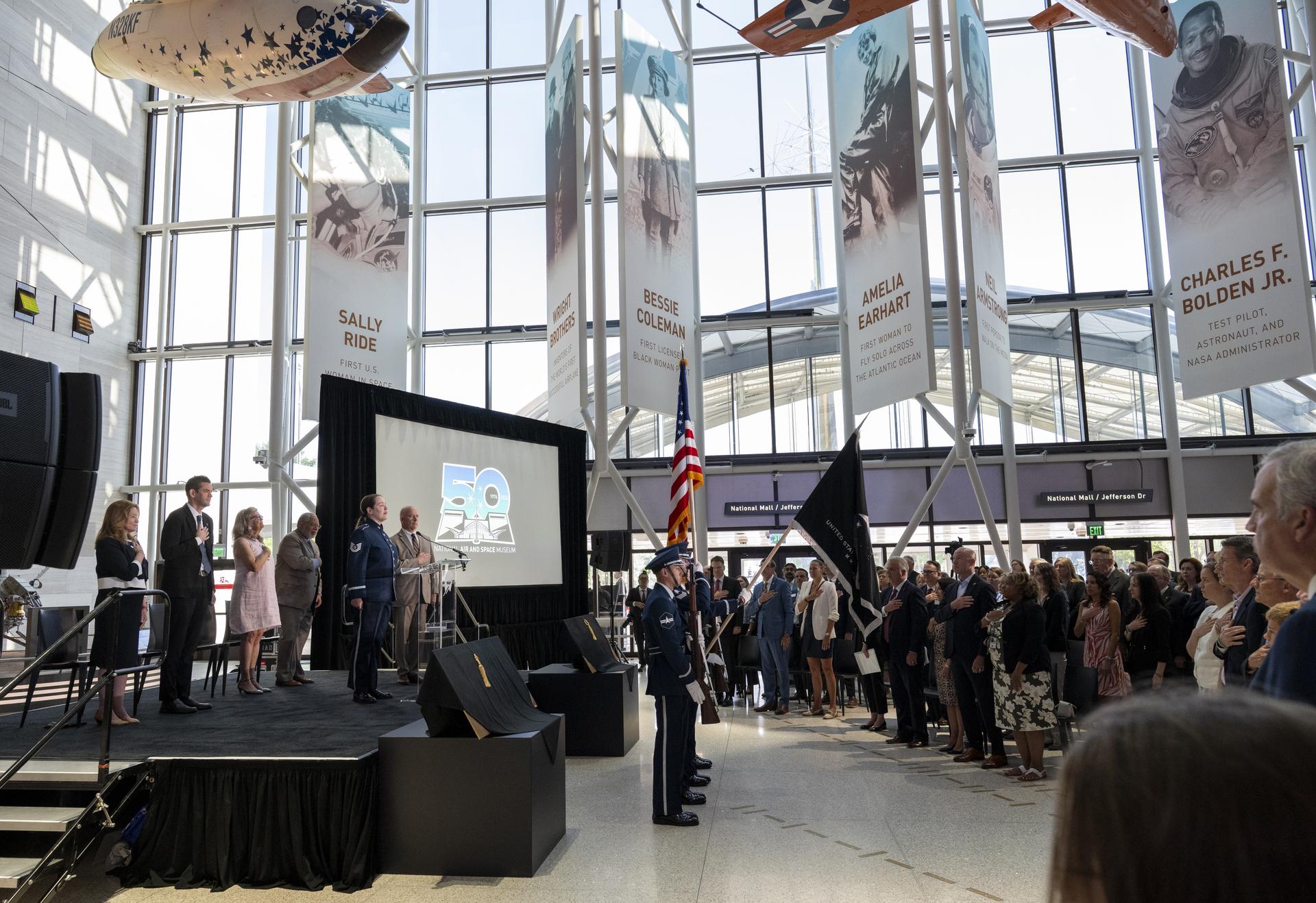 Guests stand for the singing of the national anthem prior to the Smithsonian’s National Air and Space Museum rededication ceremony Wednesday, July 1, 2026, in Washington. Photo Credit: (NASA/Keegan Barber)
