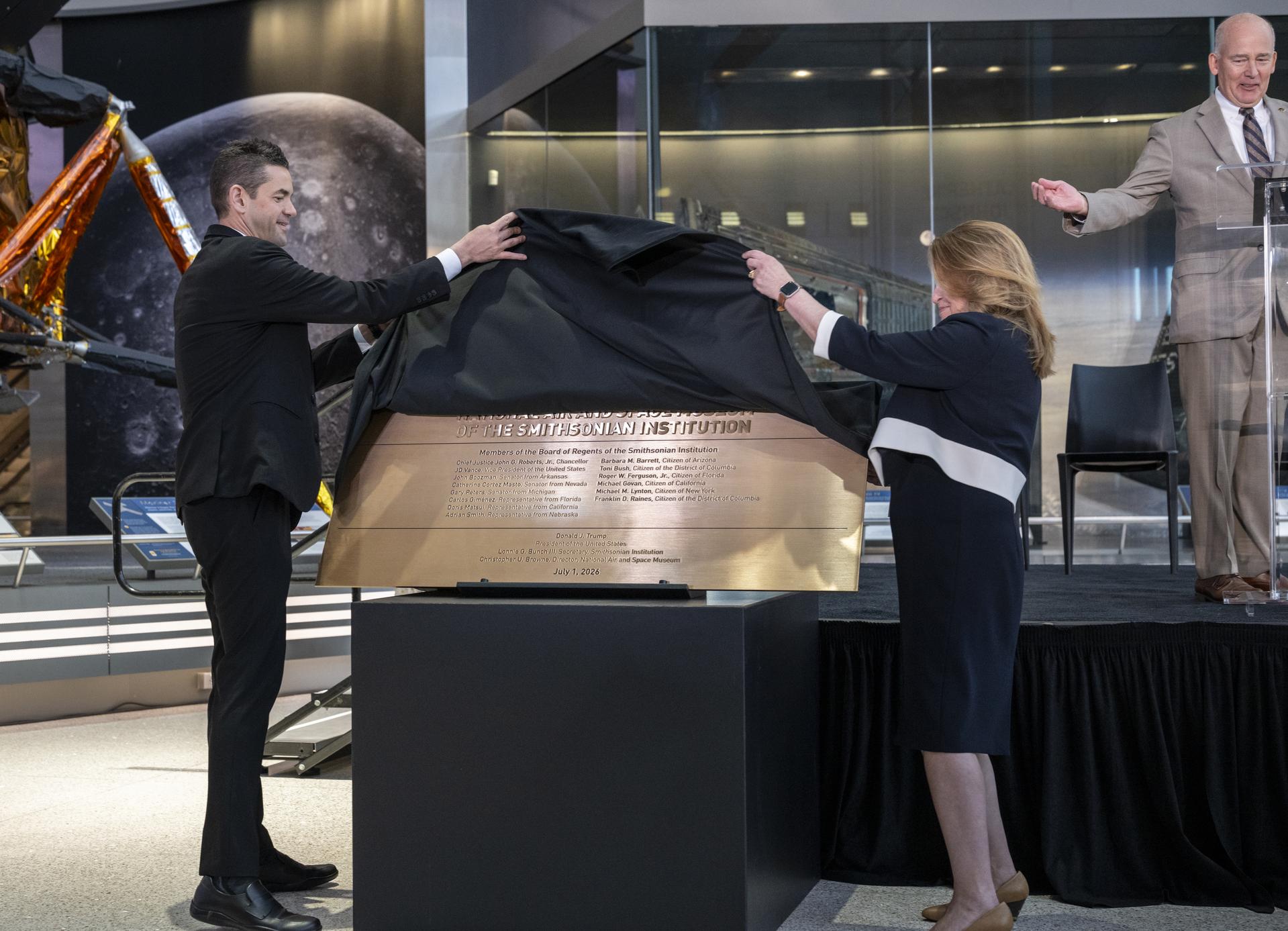 NASA Administrator Jared Isaacman, left, and Under Secretary for Science and Research at the Smithsonian Institution Ellen Stofan, right, unveil a plaque during the Smithsonian’s National Air and Space Museum rededication ceremony Wednesday, July 1, 2026, in Washington. Photo Credit: (NASA/Keegan Barber)