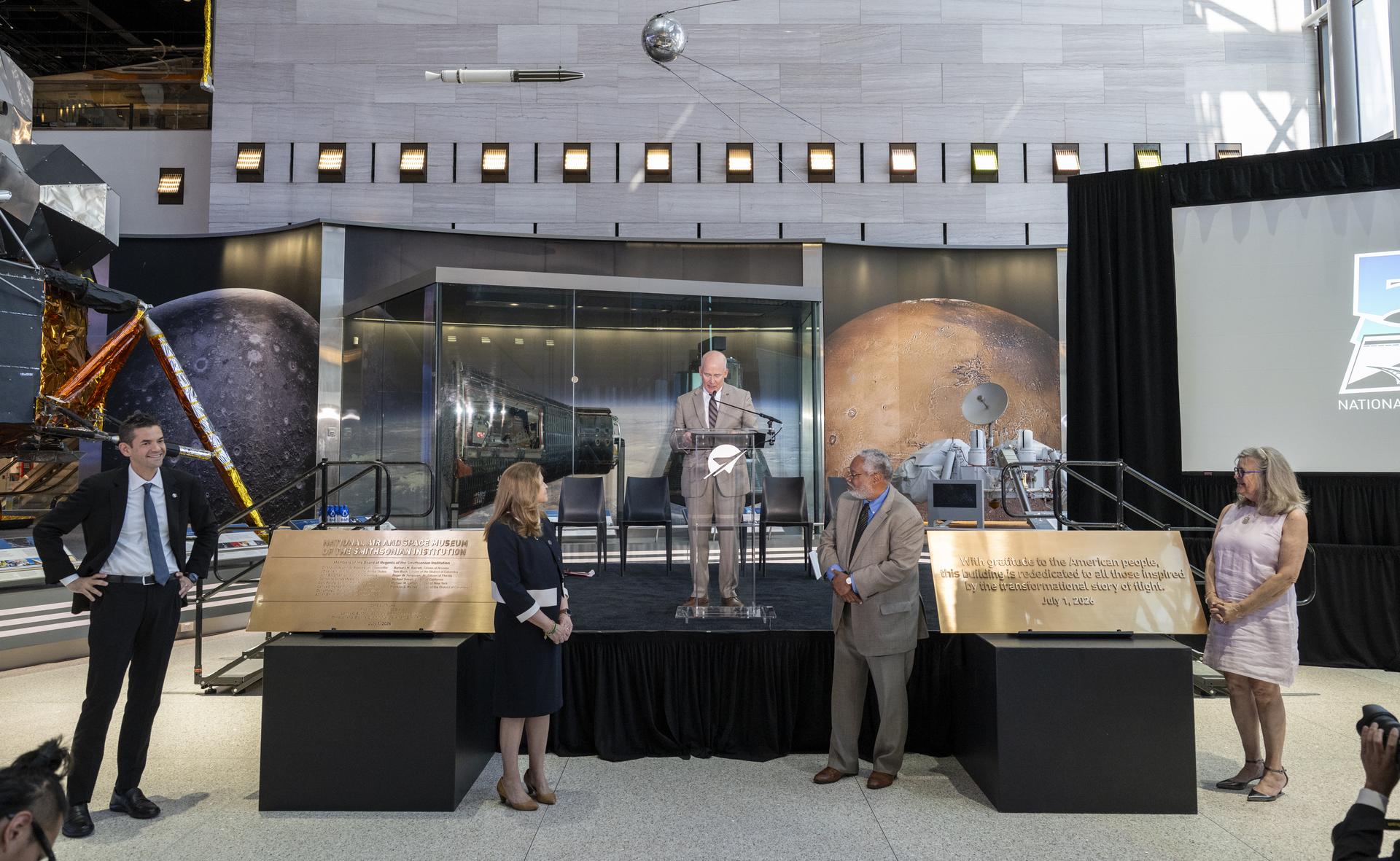 From left to right, NASA Administrator Jared Isaacman, Under Secretary for Science and Research at the Smithsonian Institution Ellen Stofan, Director of the Smithsonian’s National Air and Space Museum Christopher Browne, Secretary of the Smithsonian Institution Lonnie G. Bunch III, and Wright brother’s great-grandniece Amanda Wright Lane are seen after unveiling plaques during the Smithsonian’s National Air and Space Museum rededication ceremony Wednesday, July 1, 2026, in Washington. Photo Credit: (NASA/Keegan Barber)