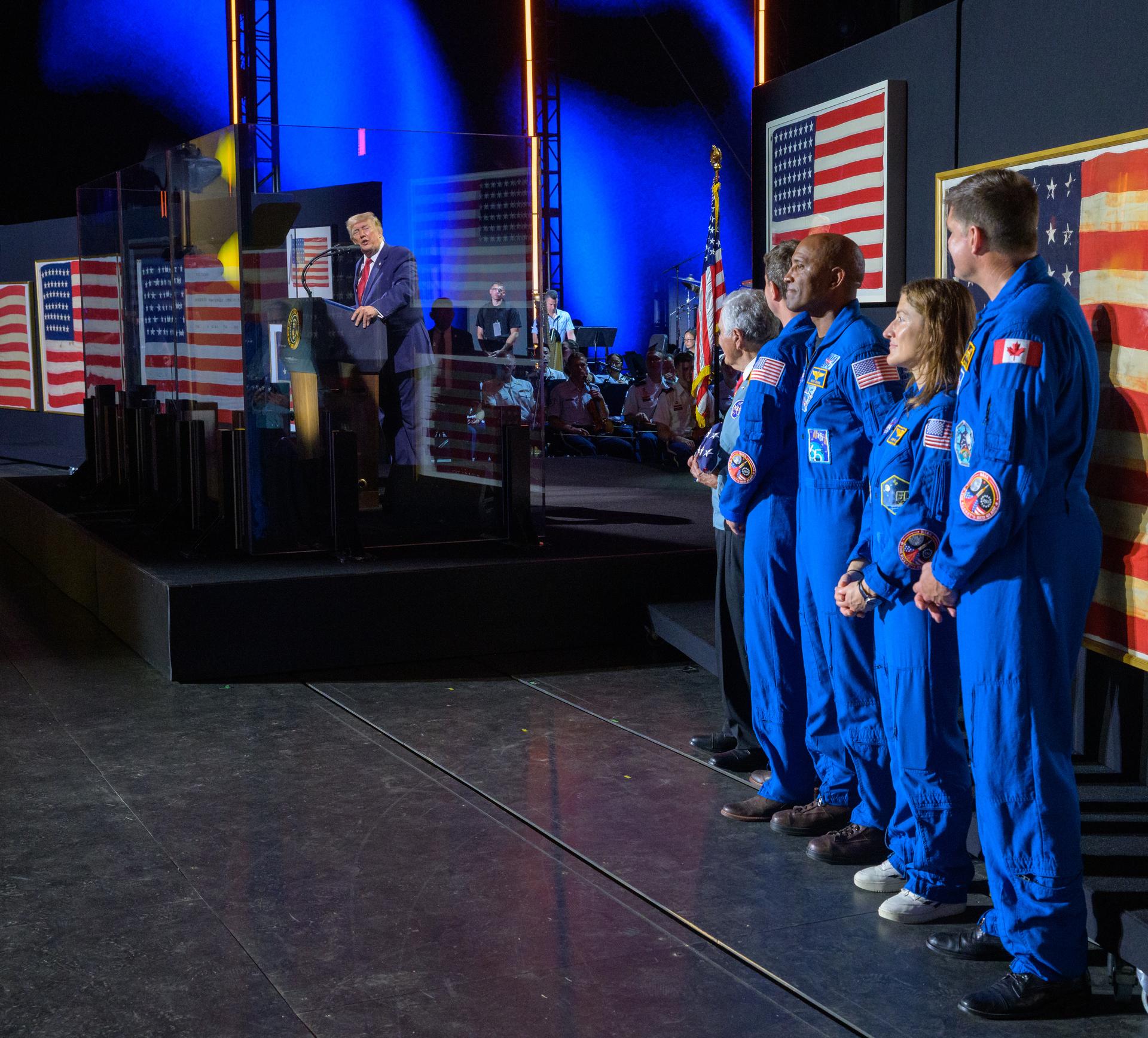 President Donald Trump recognizes NASA Apollo astronaut Harrison "Jack" Schmitt, left, NASA astronauts Reid Wiseman, commander; Victor Glover, pilot; Christina Koch, mission specialist; and CSA (Canadian Space Agency) astronaut Jeremy Hansen, mission specialist, right, during the “Salute to America” event, Saturday, July 4, 2026, on the National Mall in Washington, D.C. The United States Semiquincentennial celebrates the 250th anniversary of the adoption of the Declaration of Independence.  Photo Credit: (NASA/Bill Ingalls)