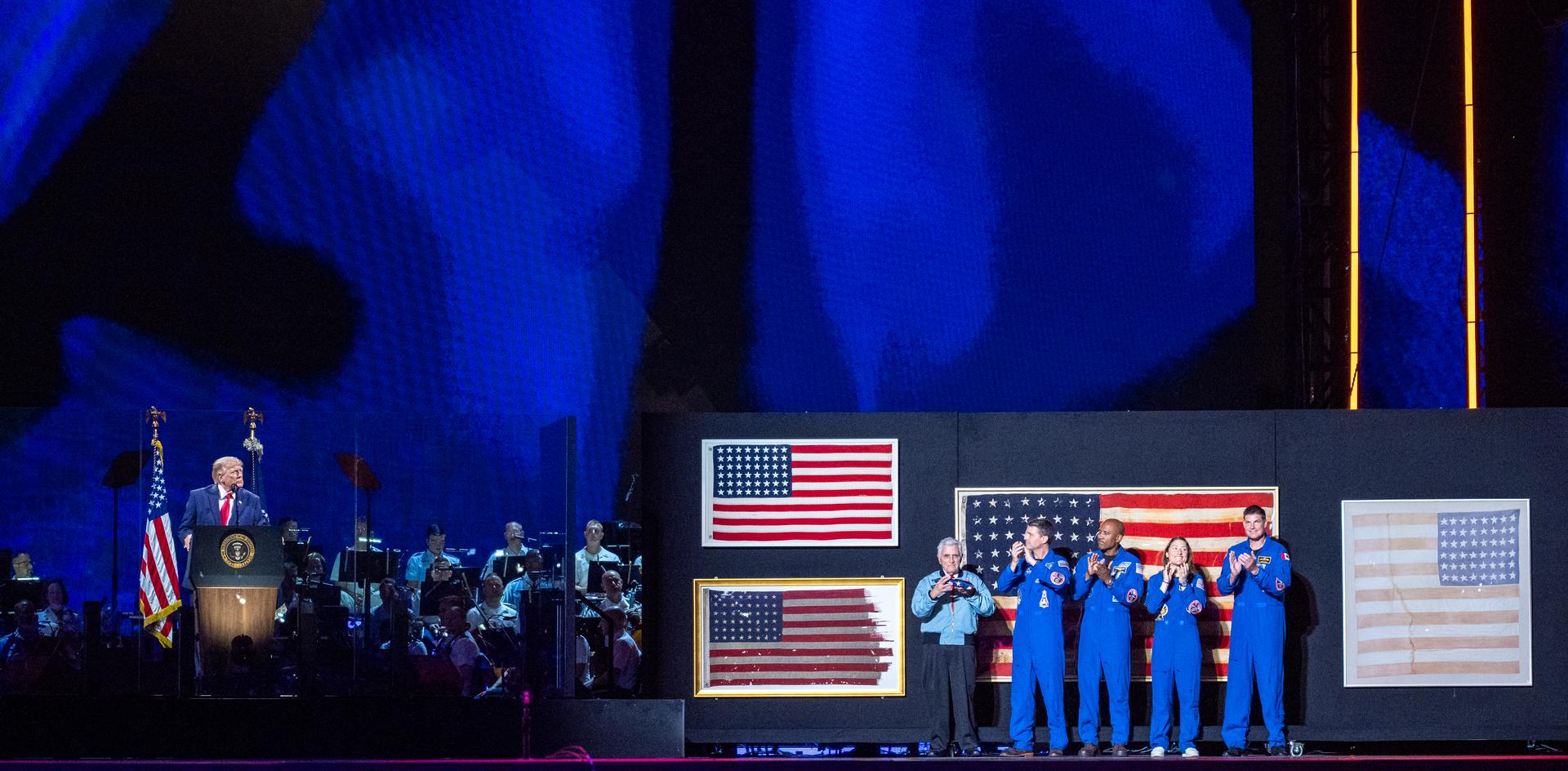 President Donald Trump recognizes NASA Apollo astronaut Harrison "Jack" Schmitt, left, NASA astronauts Reid Wiseman, commander; Victor Glover, pilot; Christina Koch, mission specialist; and CSA (Canadian Space Agency) astronaut Jeremy Hansen, mission specialist, right, during the “Salute to America” event, Saturday, July 4, 2026, on the National Mall in Washington, D.C. The United States Semiquincentennial celebrates the 250th anniversary of the adoption of the Declaration of Independence. Photo Credit: (NASA/Keegan Barber)
