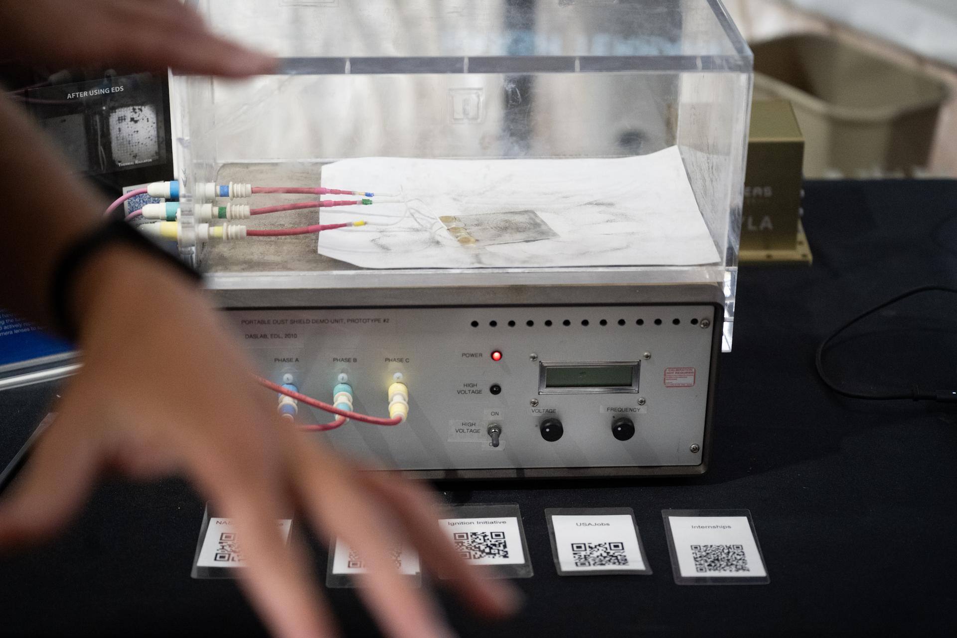 A demonstration of NASA’s Electrodynamic Dust Shield (EDS) is seen at the Great American State Fair as visitors view NASA exhibits in the American Innovation Pavilion, Wednesday, July 8, 2026, on the National Mall in Washington, D.C Photo Credit: (NASA/Joel Kowsky)