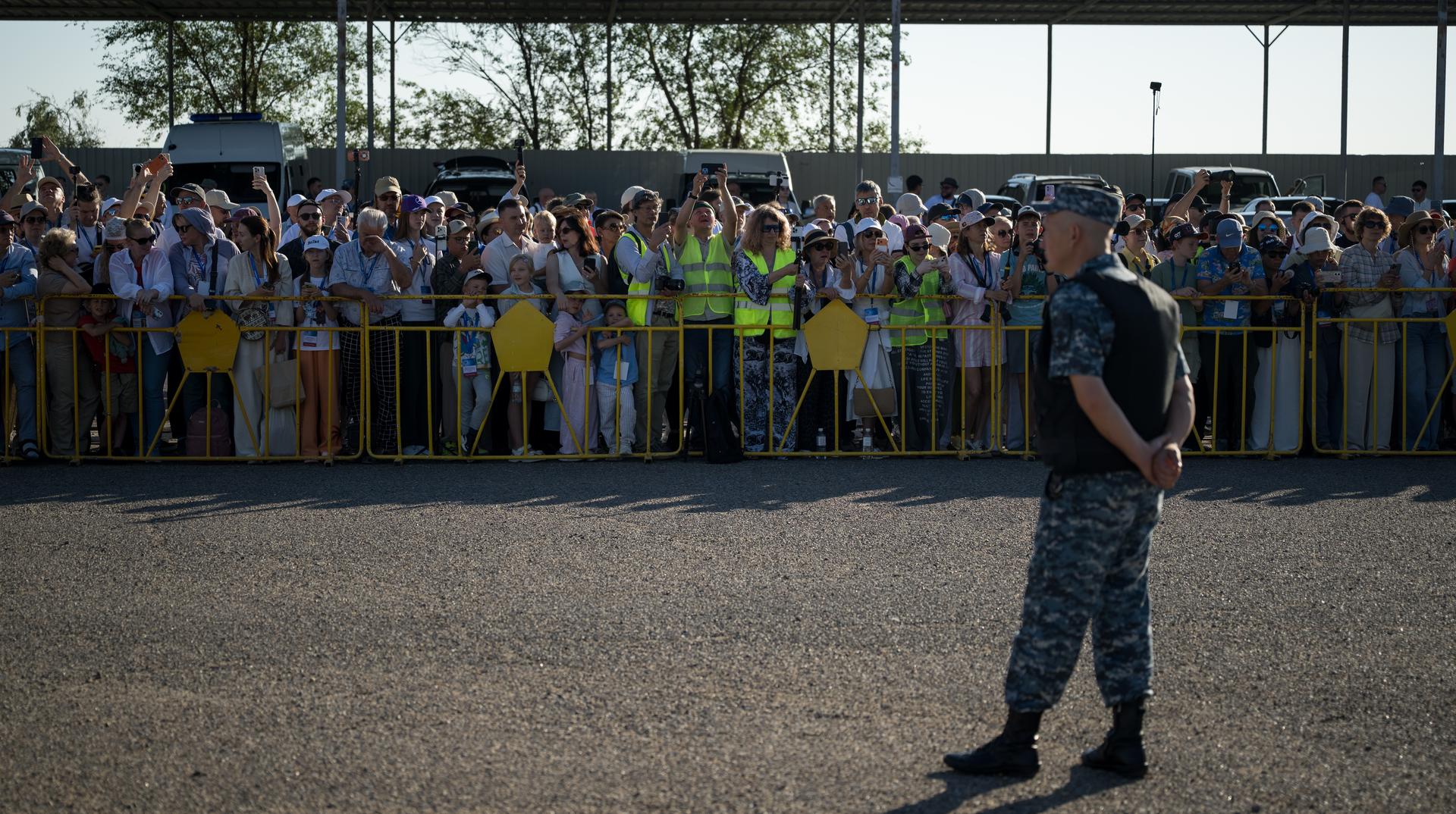 Crowds watch as the Soyuz rocket is rolled out by train to the launch pad, Saturday, July 11, 2026, at Site 31 of the Baikonur Cosmodrome in Kazakhstan. Expedition 75 crewmembers: NASA astronaut Anil Menon, Roscosmos cosmonauts Pyotr Dubrov and Anna Kikina are scheduled to launch aboard their Soyuz MS-29 spacecraft on July 14. Photo Credit: (NASA/Bill Ingalls)