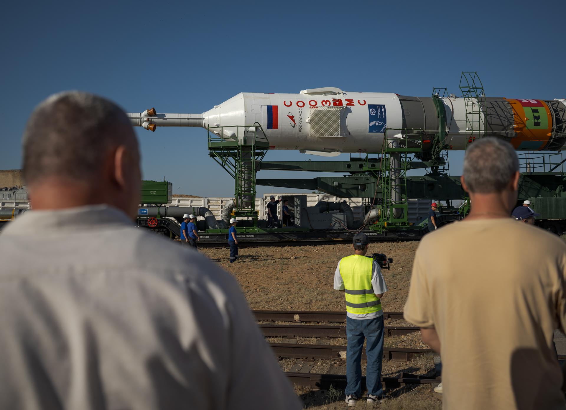 The Soyuz rocket is rolled out by train to the launch pad, Saturday, July 11, 2026, at Site 31 of the Baikonur Cosmodrome in Kazakhstan. Expedition 75 crewmembers: NASA astronaut Anil Menon, Roscosmos cosmonauts Pyotr Dubrov and Anna Kikina are scheduled to launch aboard their Soyuz MS-29 spacecraft on July 14. Photo Credit: (NASA/Bill Ingalls)