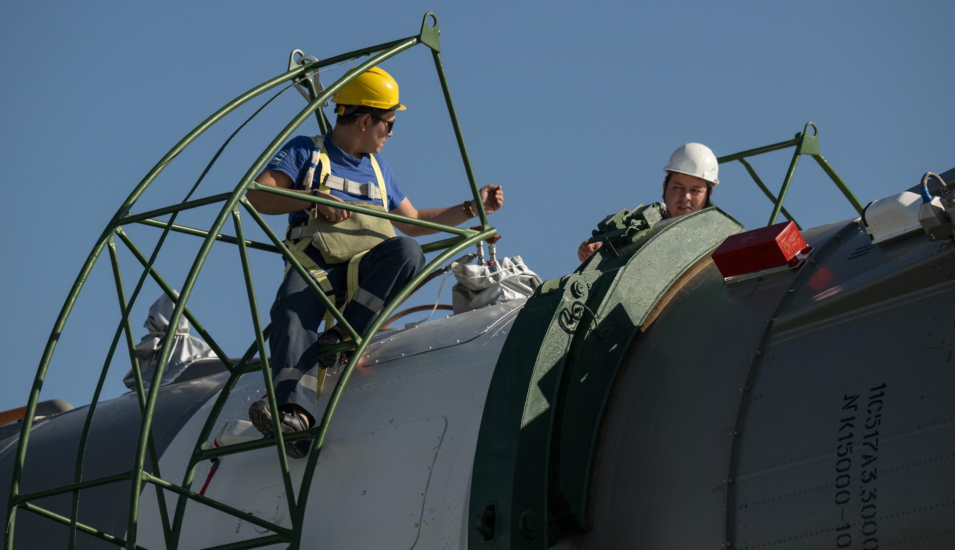 Technicians work on the Soyuz rocket after it was rolled out by train to the launch pad, Saturday, July 11, 2026, at Site 31 of the Baikonur Cosmodrome in Kazakhstan. Expedition 75 crewmembers: NASA astronaut Anil Menon, Roscosmos cosmonauts Pyotr Dubrov and Anna Kikina are scheduled to launch aboard their Soyuz MS-29 spacecraft on July 14. Photo Credit: (NASA/Bill Ingalls)