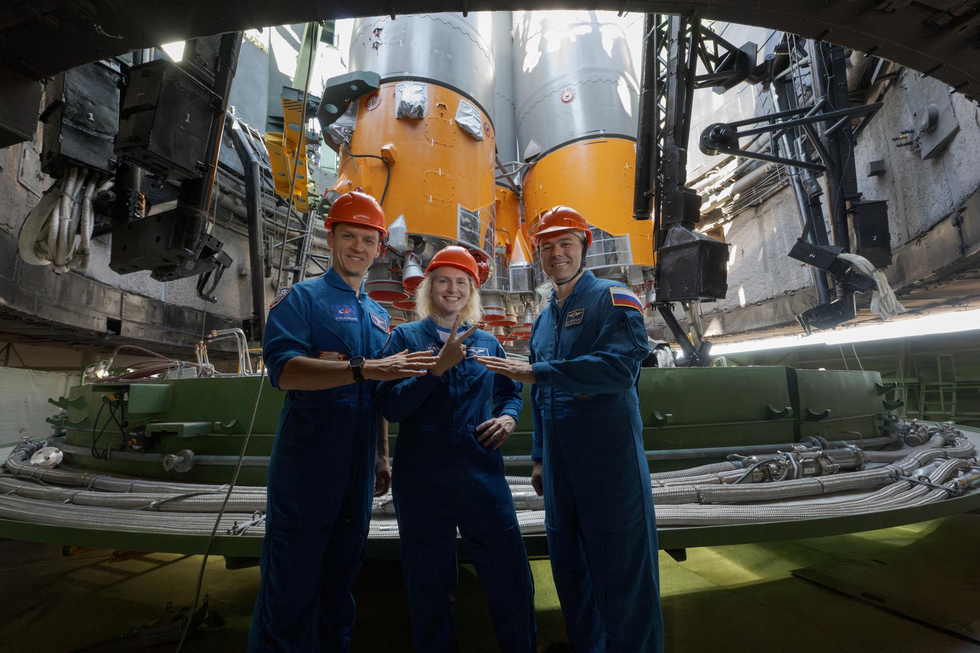 Expedition 75 backup crewmembers: Roscosmos cosmonaut Konstantin Borisov, left, NASA astronuaut Deniz Burnham, and Roscosmos cosmonaut Dmitry Petelin, pose for a group photograph in the flame trench after the Soyuz rocket was raised into position at the Site 31 launch pad of the Baikonur Cosmodrome in Kazakhstan, Saturday, July 11, 2026. Expedition 75 crewmembers: NASA astronaut Anil Menon, Roscosmos cosmonauts Pyotr Dubrov and Anna Kikina are scheduled to launch aboard their Soyuz MS-29 spacecraft on July 14. Photo Credit: (NASA/Bill Ingalls)