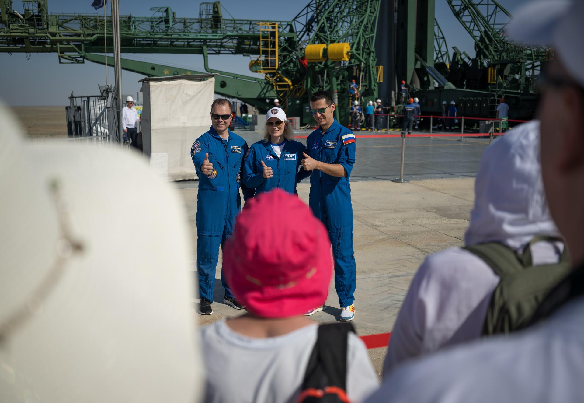 Expedition 75 backup crewmembers: Roscosmos cosmonaut Dmitry Petelin, left, NASA astronuaut Deniz Burnham, and Roscosmos cosmonaut Konstantin Borisov, right, pose for a group photograph after the Soyuz rocket was rolled out by train to the launch pad, Saturday, July 11, 2026, at Site 31 of the Baikonur Cosmodrome in Kazakhstan. Expedition 75 crewmembers: NASA astronaut Anil Menon, Roscosmos cosmonauts Pyotr Dubrov and Anna Kikina are scheduled to launch aboard their Soyuz MS-29 spacecraft on July 14. Photo Credit: (NASA/Bill Ingalls)