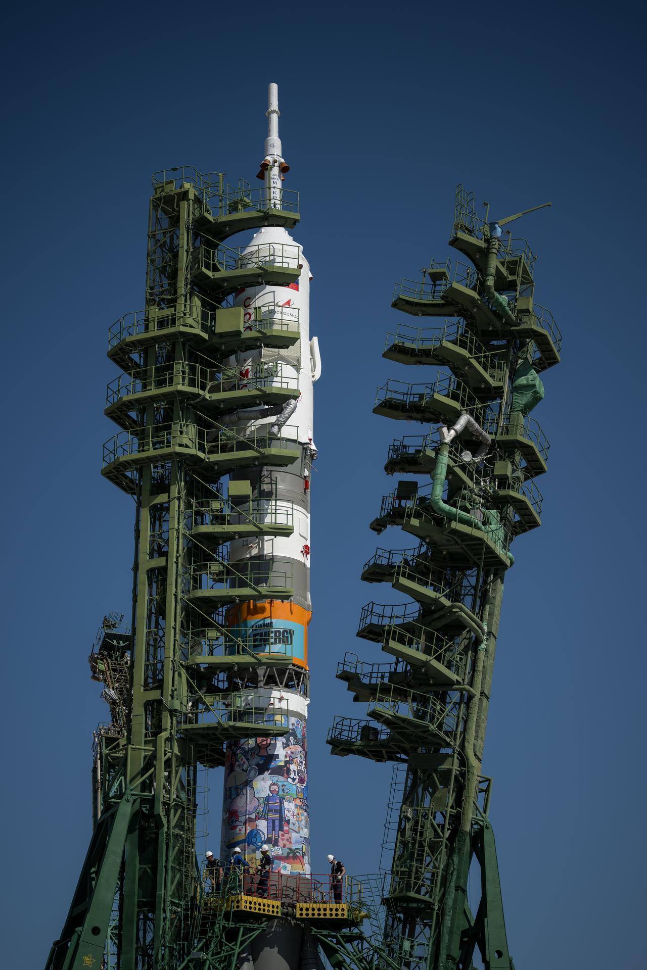 The gantry arms are raised around the Soyuz rocket after it was rolled out to the Site 31 launch pad of the Baikonur Cosmodrome in Kazakhstan, Saturday, July 11, 2026. Expedition 75 crewmembers: NASA astronaut Anil Menon, Roscosmos cosmonauts Pyotr Dubrov and Anna Kikina are scheduled to launch aboard their Soyuz MS-29 spacecraft on July 14. Photo Credit: (NASA/Bill Ingalls)