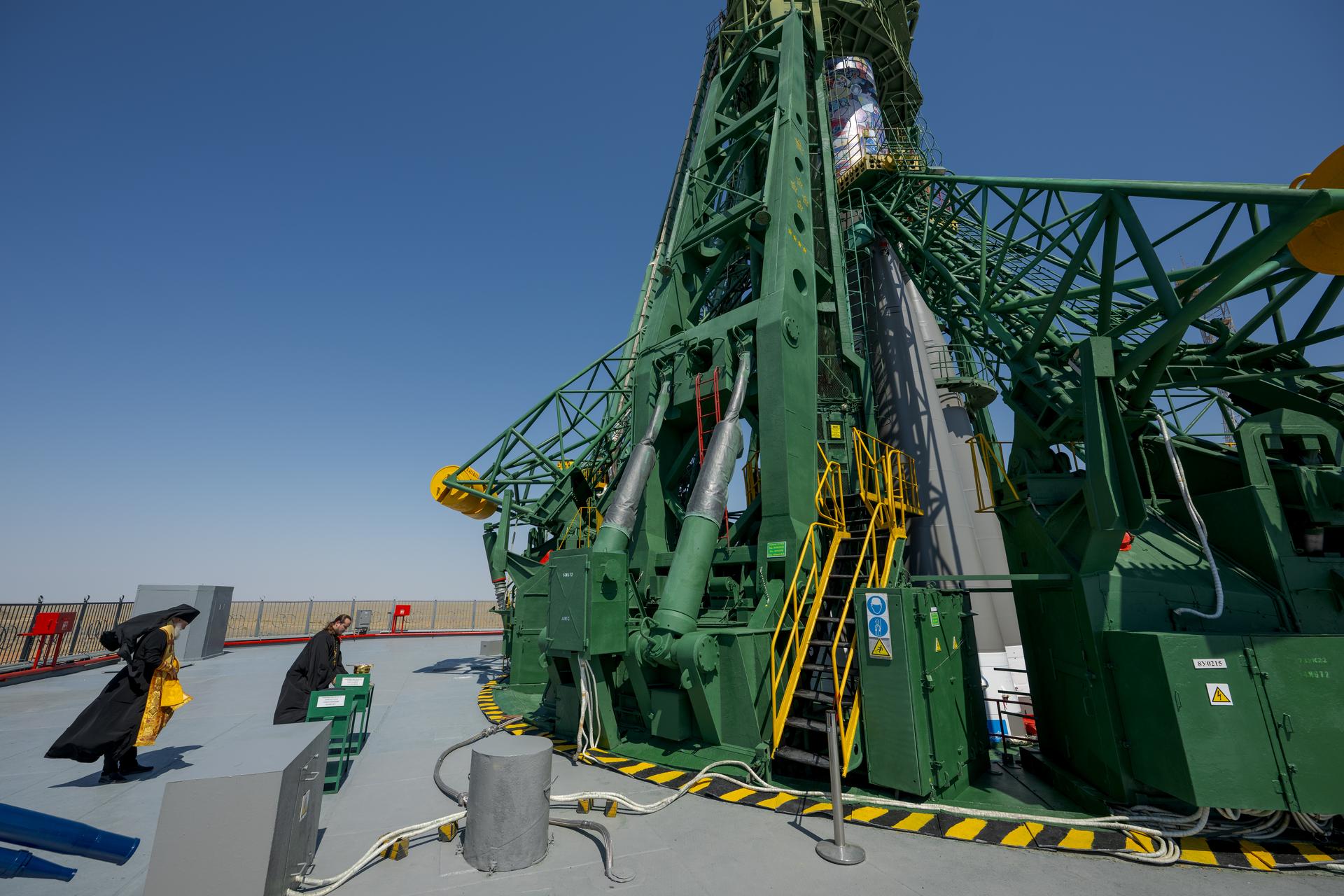 Russian Orthodox Priest blesses the Soyuz rocket, Monday, July 13, 2026 at the Baikonur Cosmodrome Site 31 launch pad in Kazakhstan. Expedition 75 crewmembers: NASA astronaut Anil Menon, Roscosmos cosmonauts Pyotr Dubrov and Anna Kikina are scheduled to launch aboard the Soyuz MS-29 spacecraft to the International Space Station on July 14. Photo Credit: (NASA/Bill Ingalls)