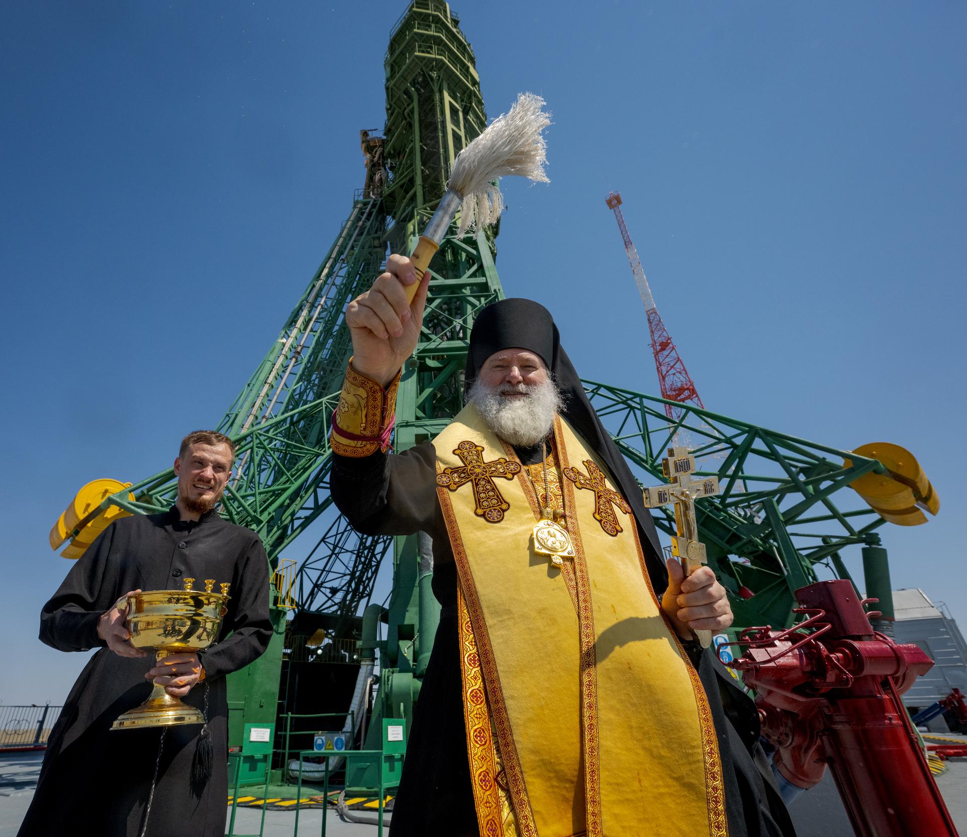 Russian Orthodox Priest blesses the Soyuz rocket, Monday, July 13, 2026 at the Baikonur Cosmodrome Site 31 launch pad in Kazakhstan. Expedition 75 crewmembers: NASA astronaut Anil Menon, Roscosmos cosmonauts Pyotr Dubrov and Anna Kikina are scheduled to launch aboard the Soyuz MS-29 spacecraft to the International Space Station on July 14. Photo Credit: (NASA/Bill Ingalls)