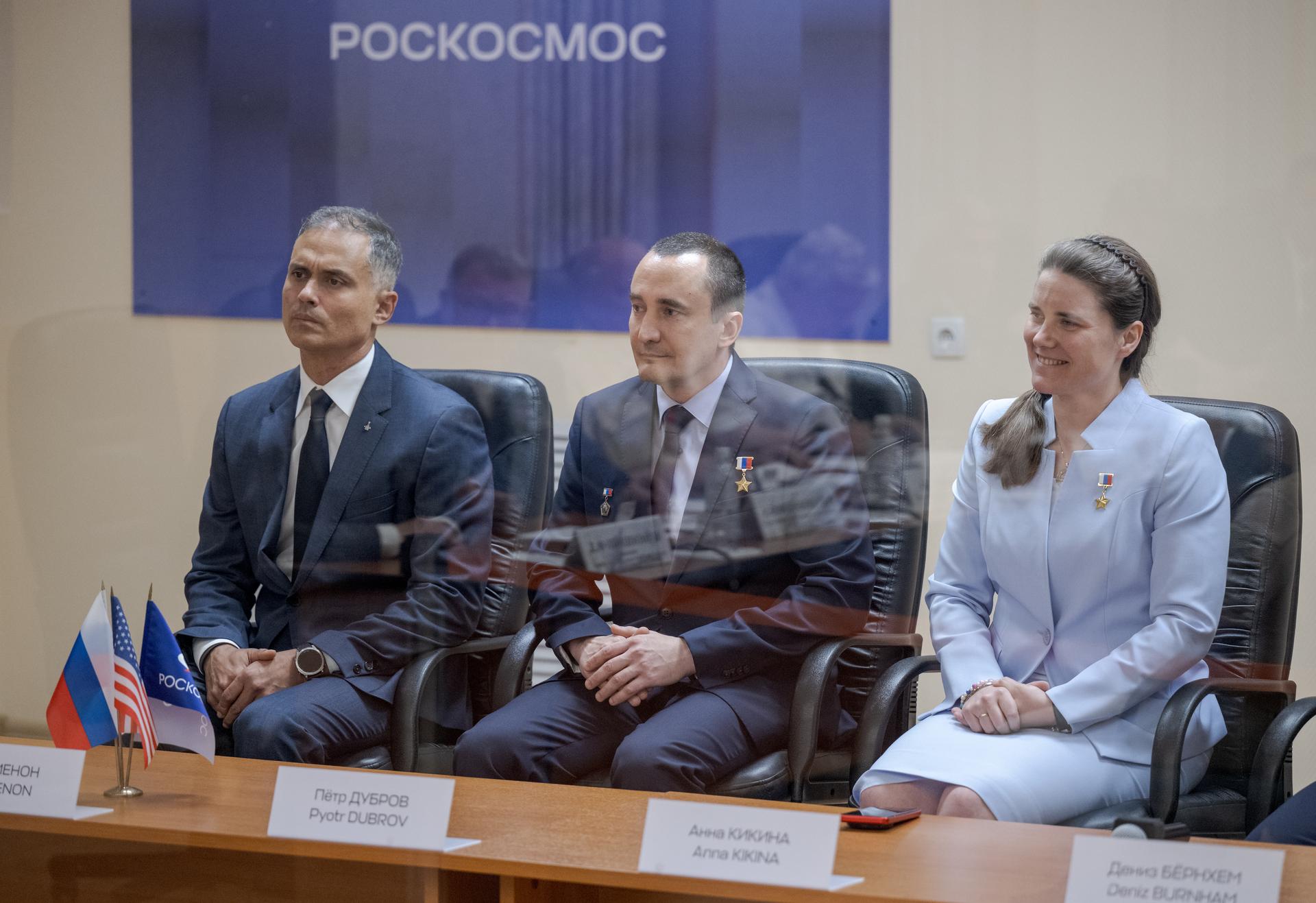 Expedition 75 crewmembers: NASA astronaut Anil Menon, left, Roscosmos cosmonauts Pyotr Dubrov and Anna Kikina, right, are seen during the State Commission meeting to approve the Soyuz launch of Expedition 75 to the International Space Station, Monday, July 13, 2026 at the Cosmonaut Hotel in Baikonur, Kazakhstan. Menon, Dubrov, and Kikina are scheduled to launch aboard the Soyuz MS-29 spacecraft to the International Space Station on July 14. Photo Credit: (NASA/Bill Ingalls)