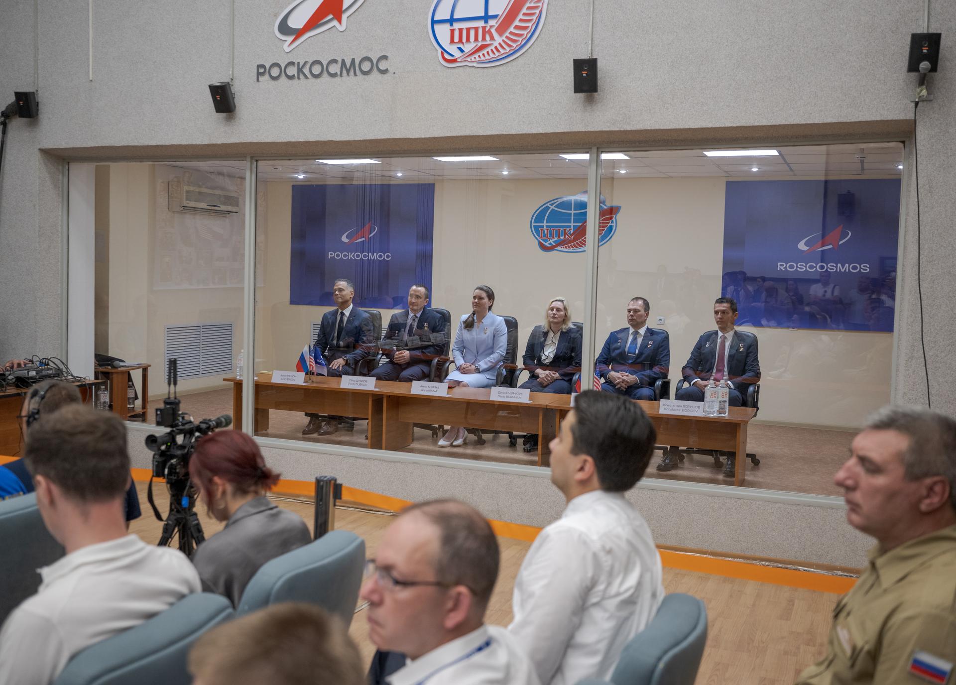 Expedition 75 crewmembers: NASA astronaut Anil Menon, left, Roscosmos cosmonauts Pyotr Dubrov and Anna Kikina, and backup crew members: NASA astronaut Deniz Burnham, Roscosmos cosmonauts Dmitry Petelin and Konstantin Borisov, right, are seen during the State Commission meeting to approve the Soyuz launch of Expedition 75 to the International Space Station, Monday, July 13, 2026 at the Cosmonaut Hotel in Baikonur, Kazakhstan. Menon, Dubrov, and Kikina are scheduled to launch aboard the Soyuz MS-29 spacecraft to the International Space Station on July 14. Photo Credit: (NASA/Bill Ingalls)
