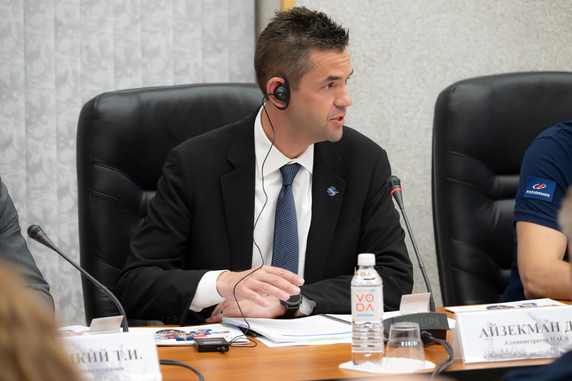 NASA Administrator Jared Isaacman speaks during the State Commission meeting to approve the Soyuz MS-29 launch to the International Space Station, Monday, July 13, 2026, at the Cosmonaut Hotel in Baikonur, Kazakhstan. Expedition 75 crewmembers NASA astronaut Anil Menon and Roscosmos cosmonauts Pyotr Dubrov and Anna Kikina are scheduled to launch aboard the Soyuz MS-29 spacecraft to the International Space Station on July 14. Photo Credit: (NASA/John Kraus)