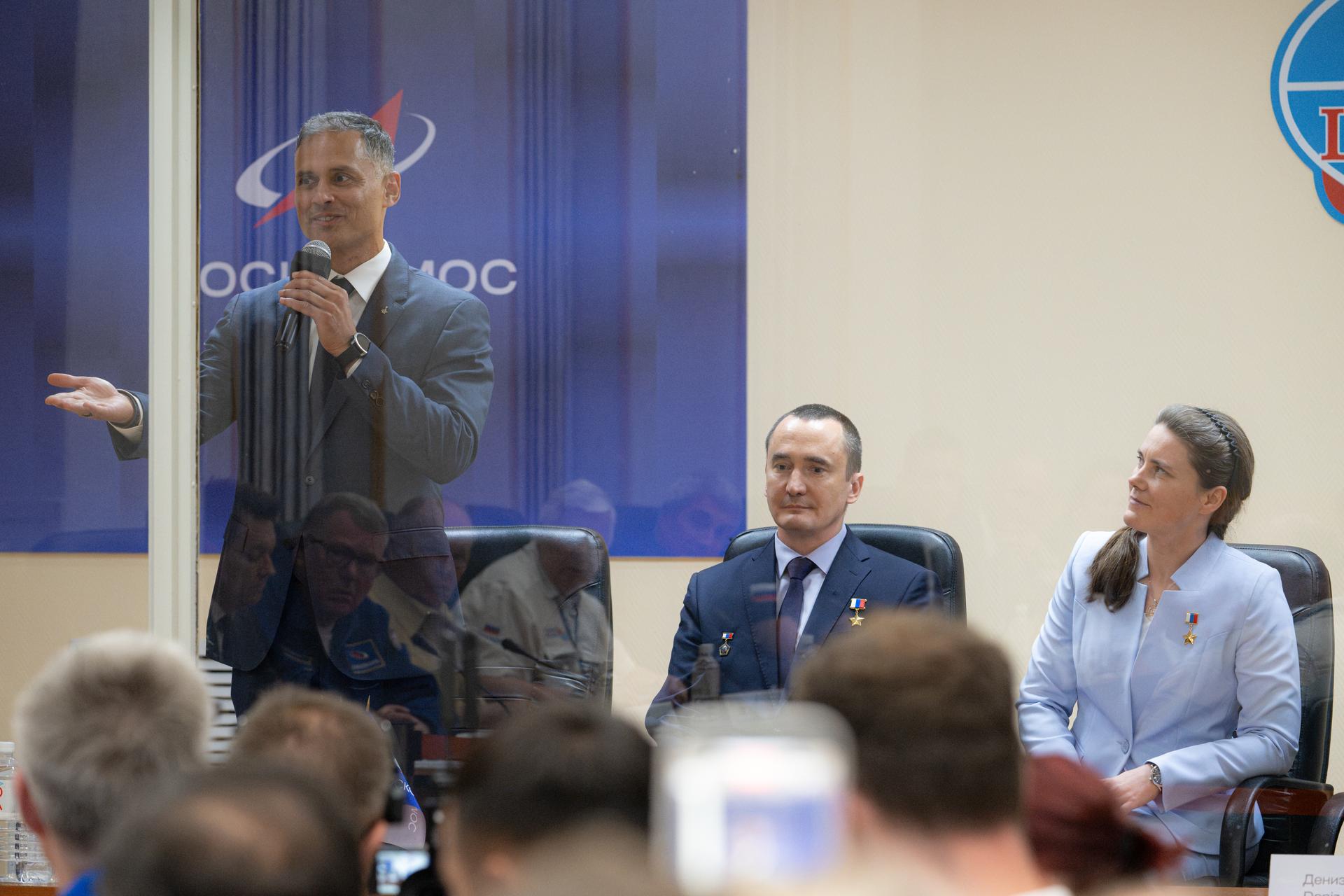 Expedition 75 crewmembers NASA astronaut Anil Menon, left, and Roscosmos cosmonauts Pyotr Dubrov and Anna Kikina, right, are seen during the State Commission meeting to approve the Soyuz MS-29 launch to the International Space Station, Monday, July 13, 2026, at the Cosmonaut Hotel in Baikonur, Kazakhstan. Menon, Dubrov, and Kikina are scheduled to launch aboard the Soyuz MS-29 spacecraft to the International Space Station on July 14. Photo Credit: (NASA/John Kraus)