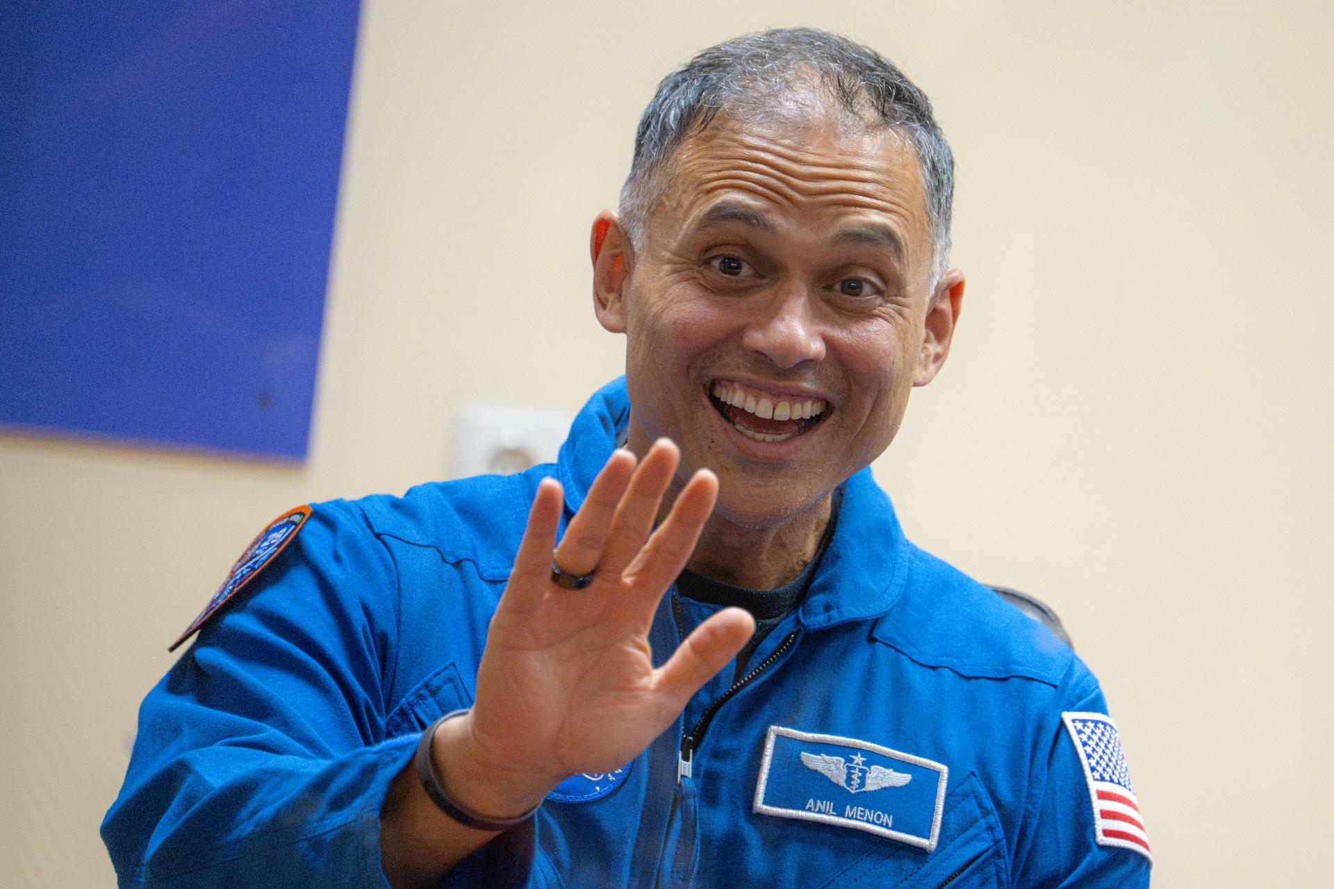 NASA astronaut Anil Menon is seen in quarantine, behind glass, during a press conference, Monday, July 13, 2026, at the Cosmonaut Hotel in Baikonur, Kazakhstan. Expedition 75 crewmembers NASA astronaut Anil Menon and Roscosmos cosmonauts Pyotr Dubrov and Anna Kikina are scheduled to launch aboard the Soyuz MS-29 spacecraft to the International Space Station on July 14. Photo Credit: (NASA/John Kraus)